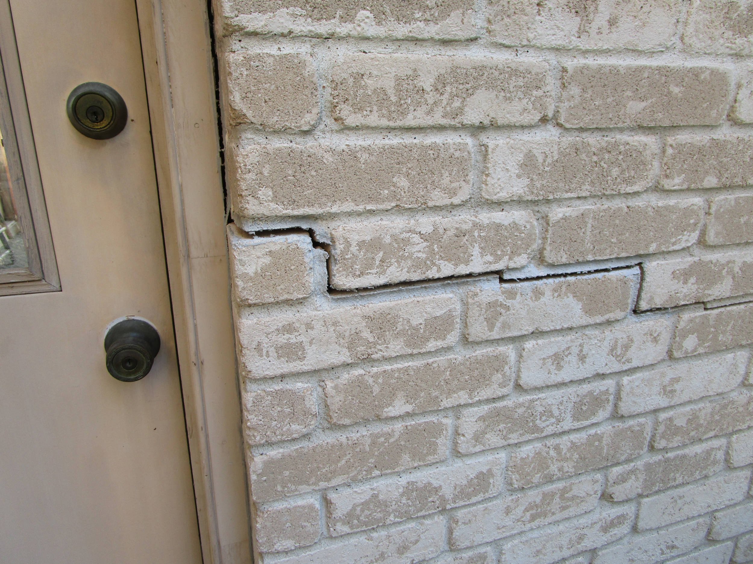 Stairstep crack in brick mortar indicating need for a foundation inspection