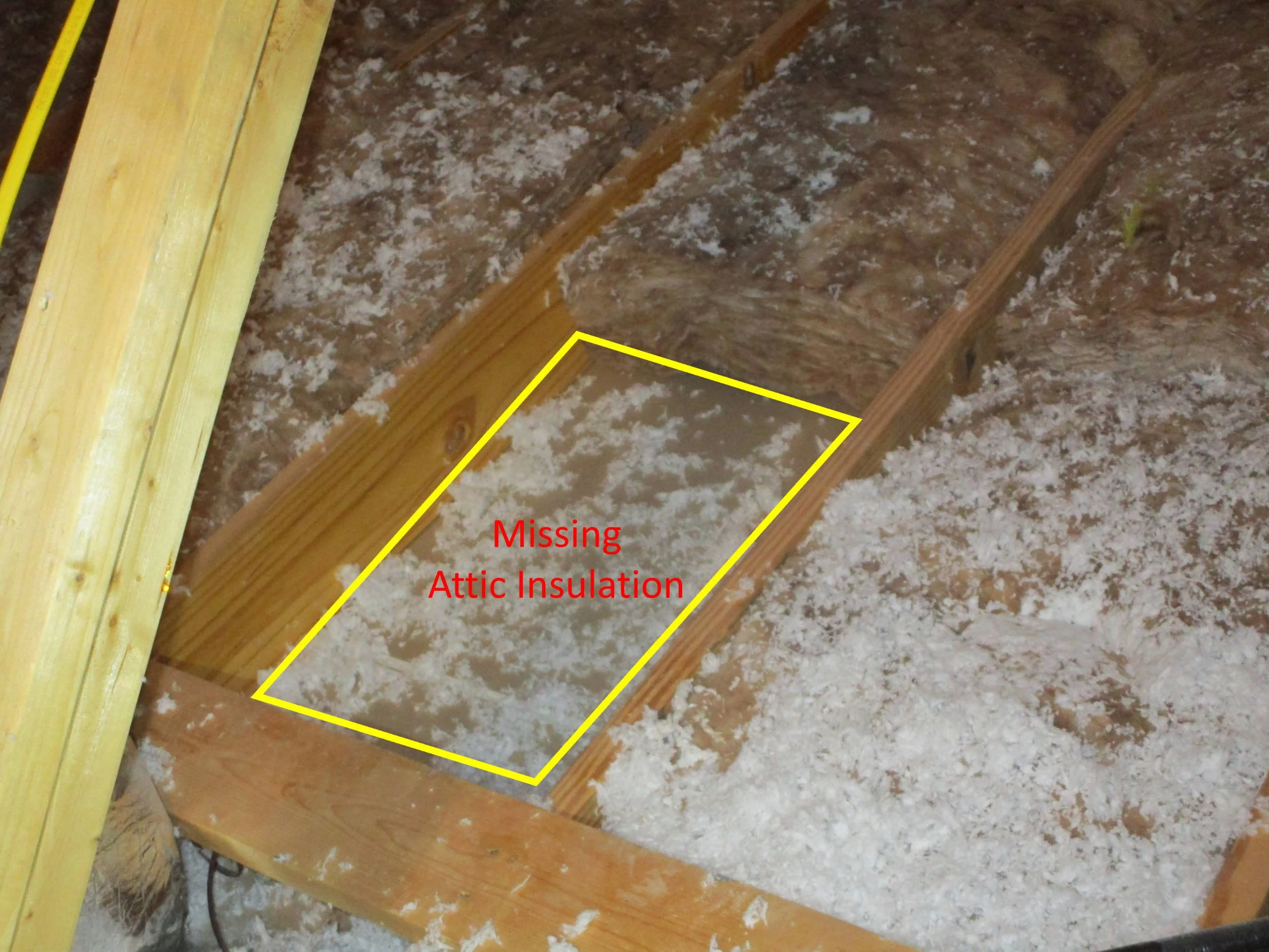 Section of attic ceiling that is missing insulation