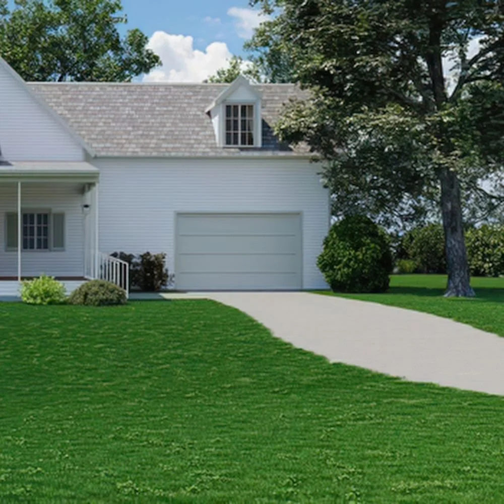 Lawn mower operator wearing green overalls, orange shirt, and orange cap, filling a lawn mower with grass clippings in a yard with lush green bushes and trees.