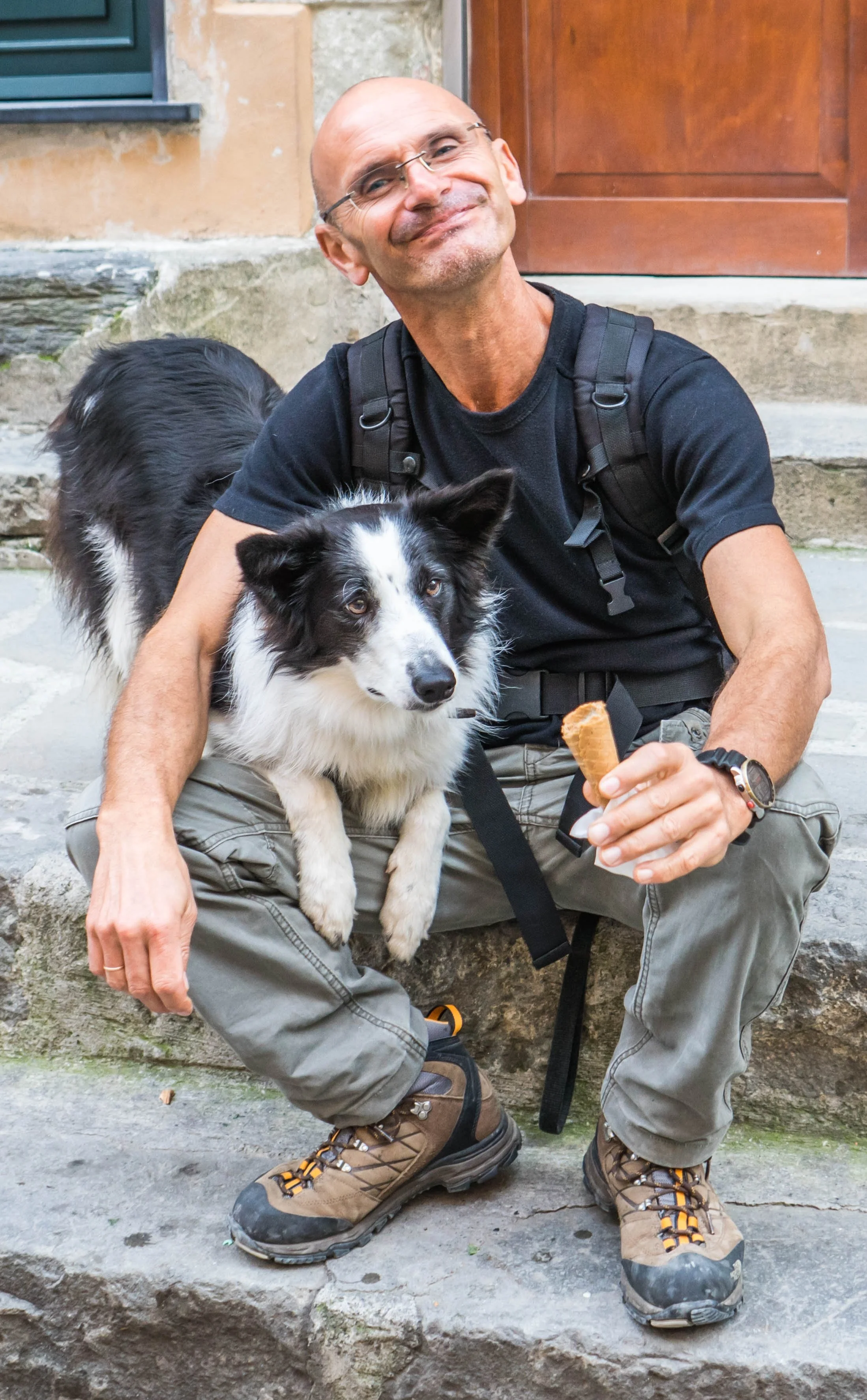 MAN HAVING AN ICE CREAM WITH HIS DOG