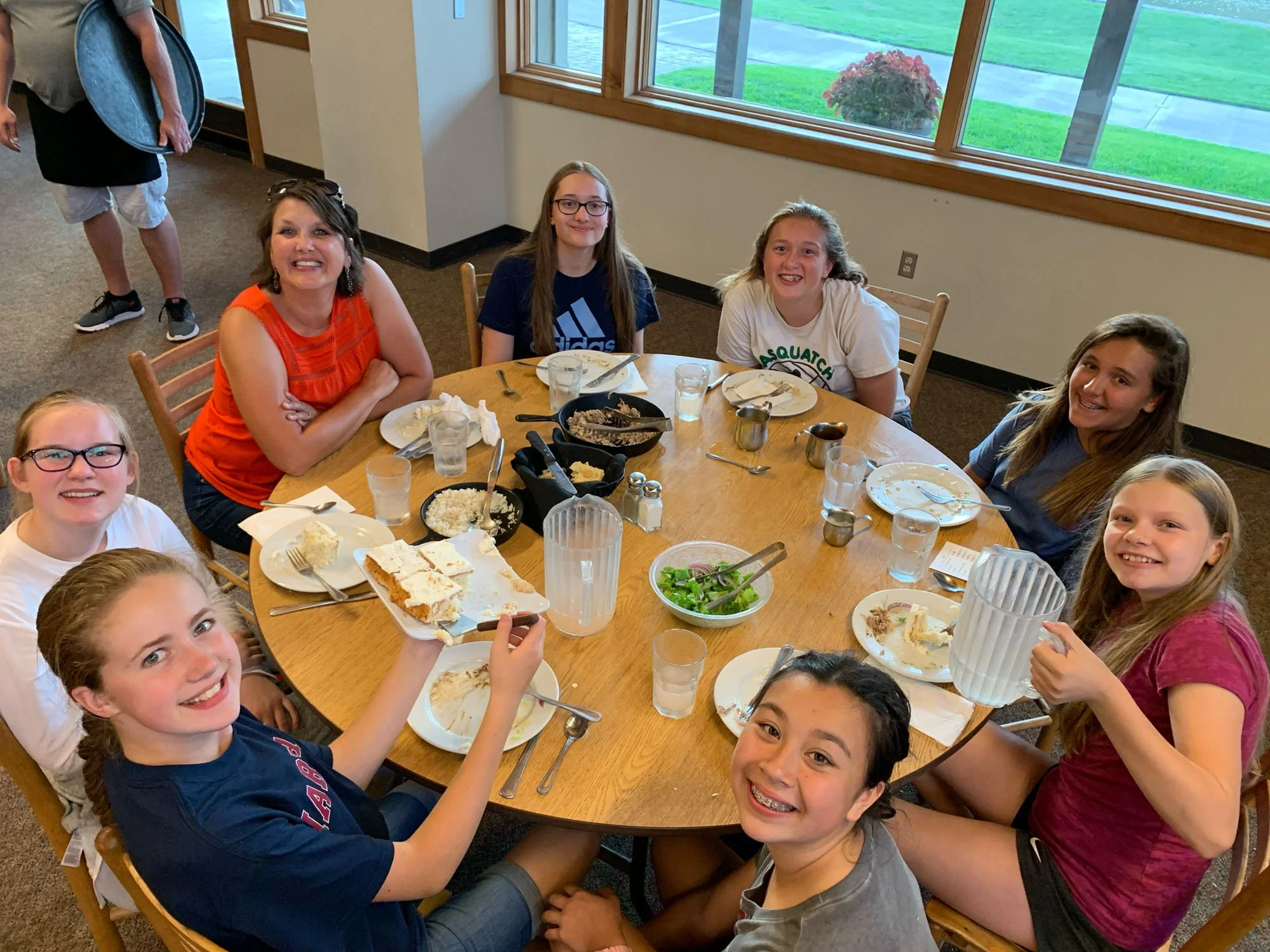 Trinity students sharing a meal around a table