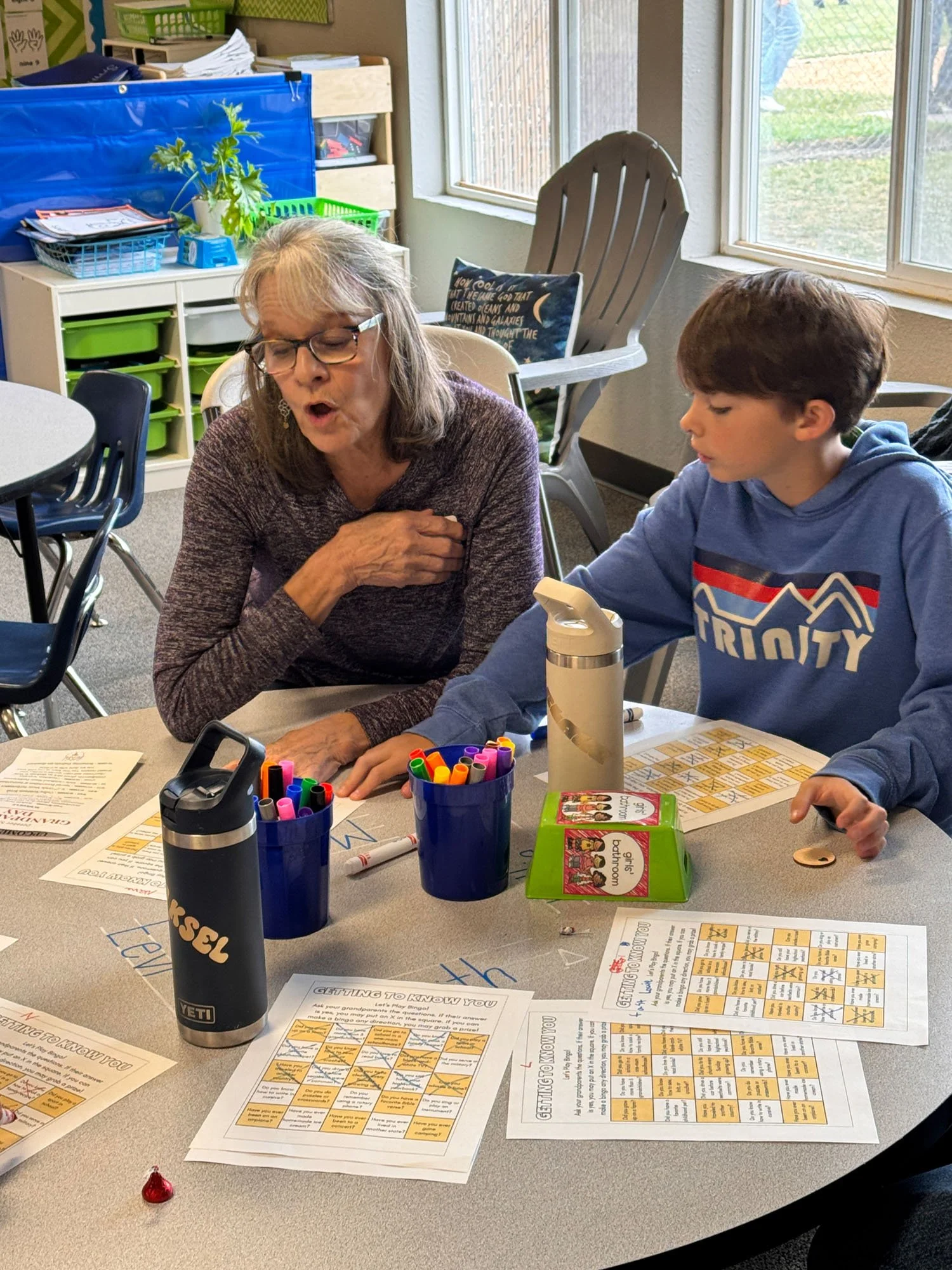 Trinity grandparent and student playing a getting-to-know-you game in the classroom