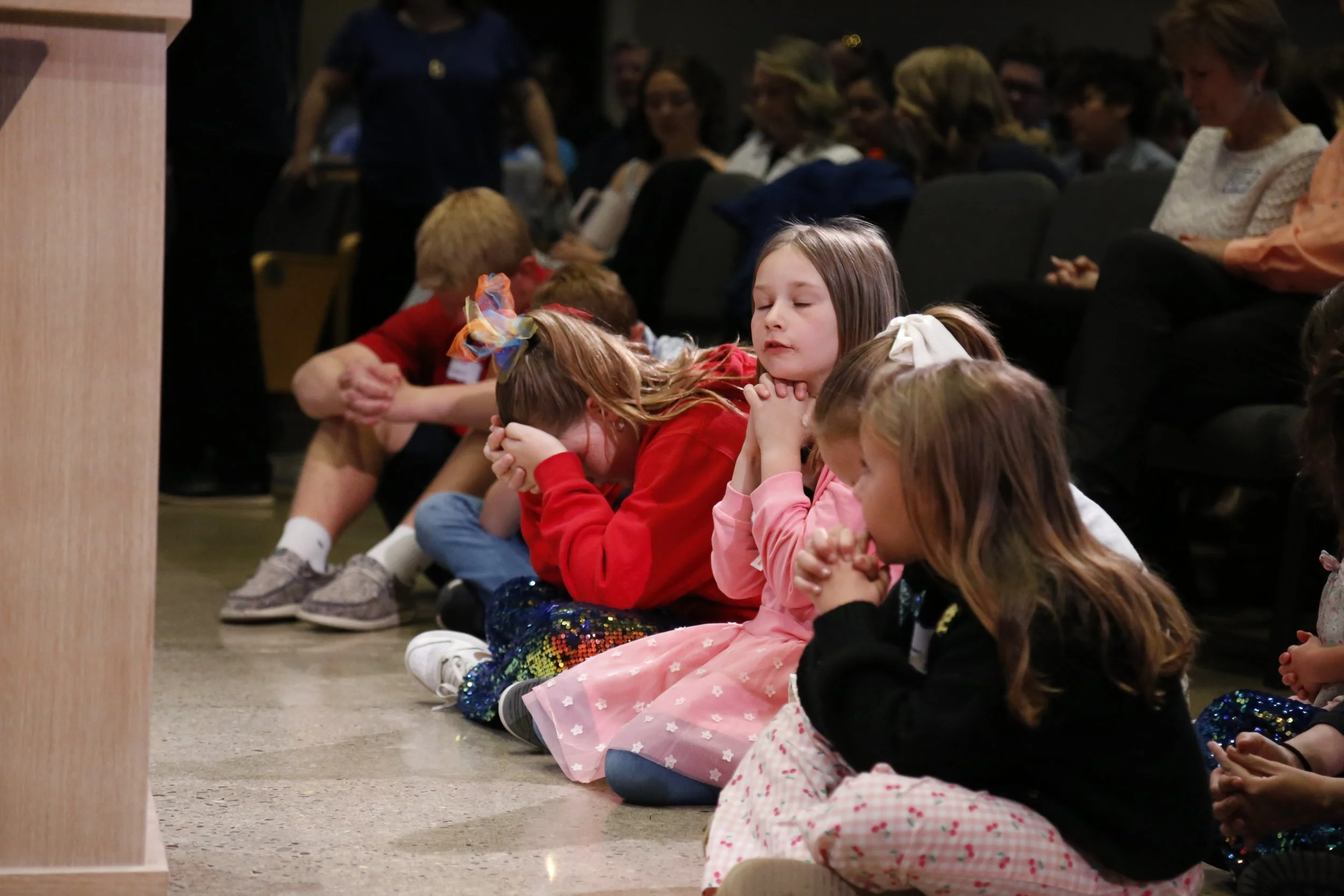 Young Trinity students praying