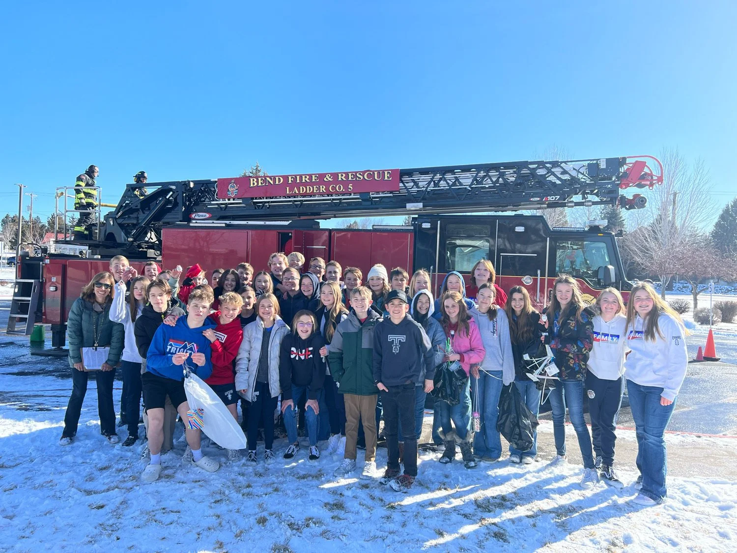 Trinity students gathered in front of a Bend Fire & Rescue ladder truck