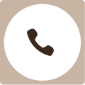 Icon of a phone handset in a circular beige background