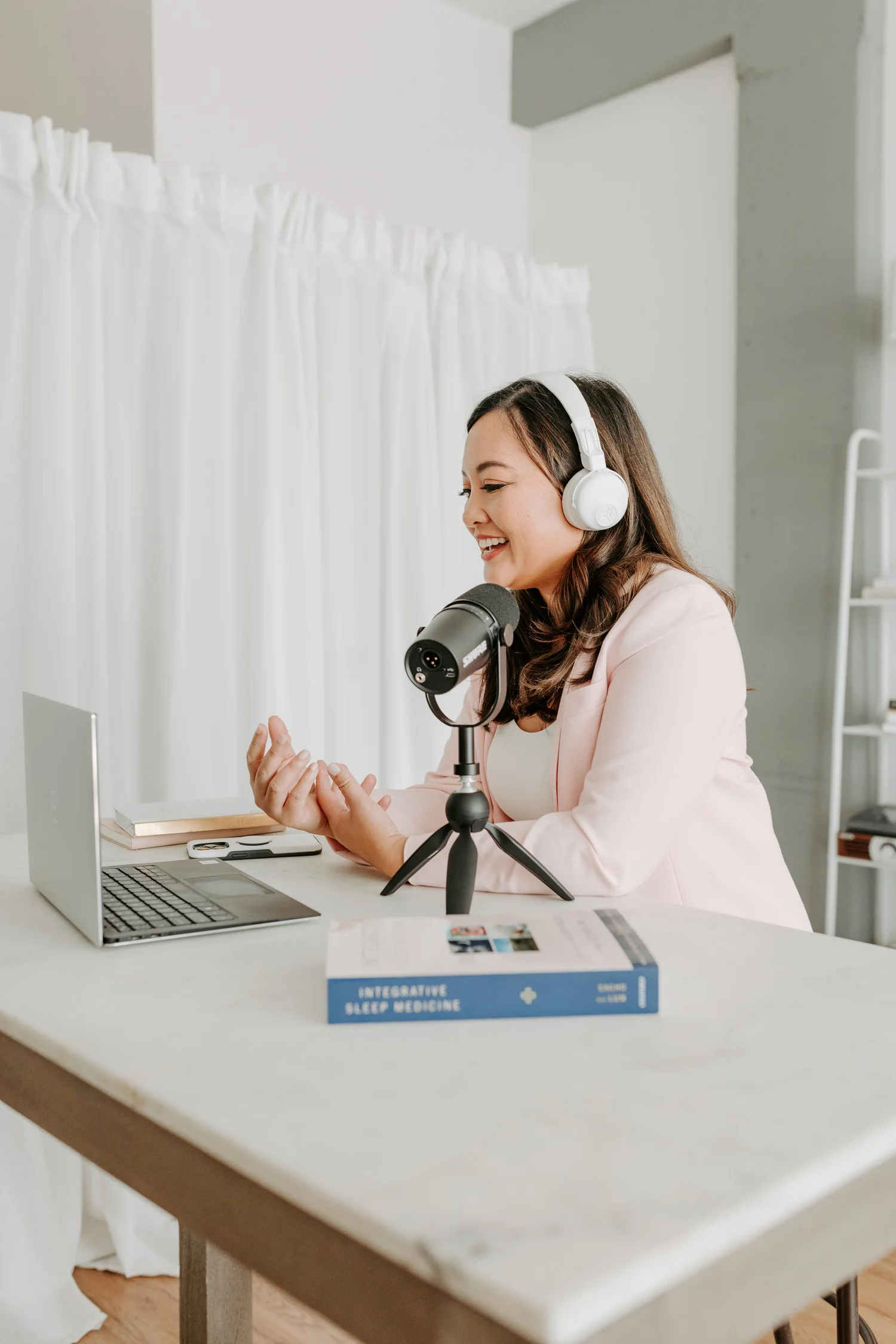 Dr. Cacho recording a podcast interview with headphones and a microphone