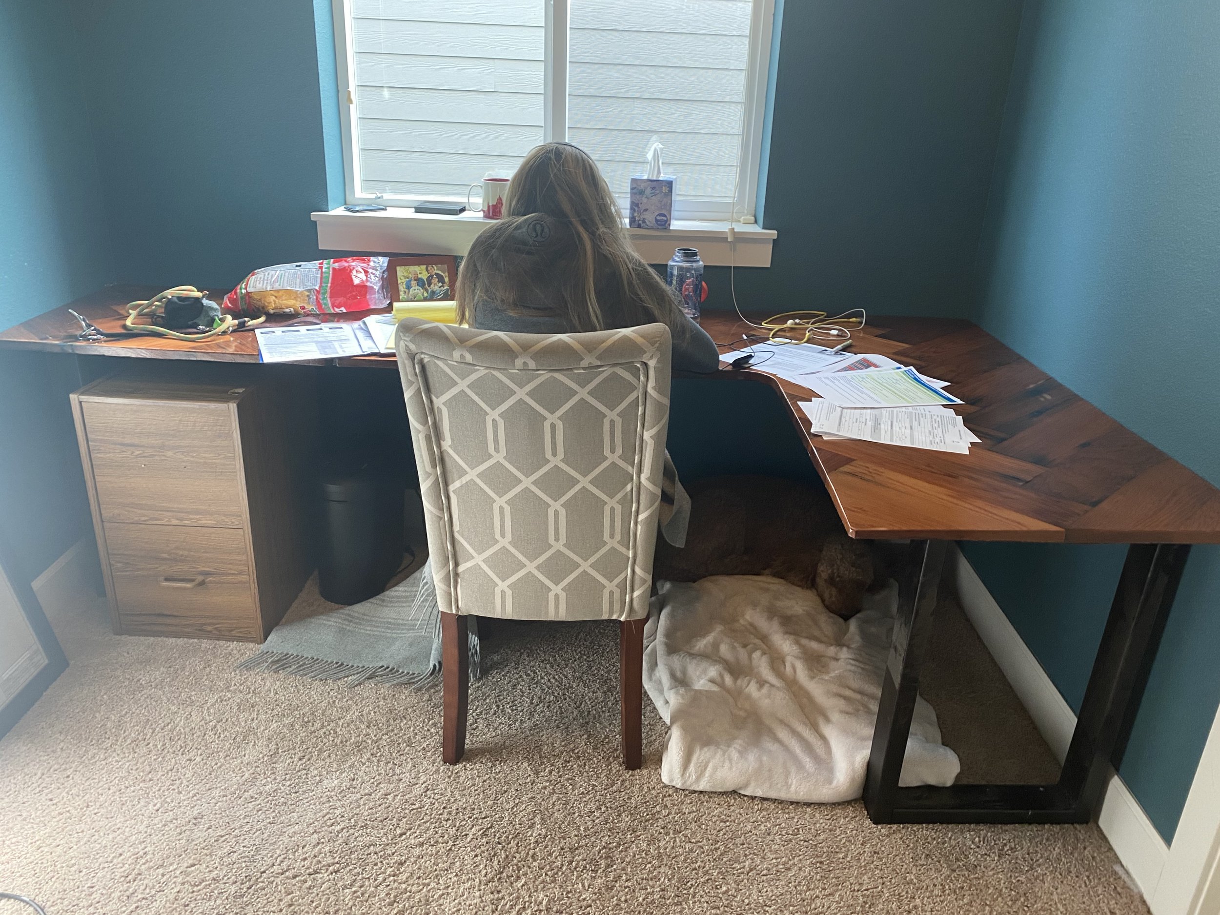 Before renovation: a home office with bare walls and an empty corner, before custom built-ins and desk