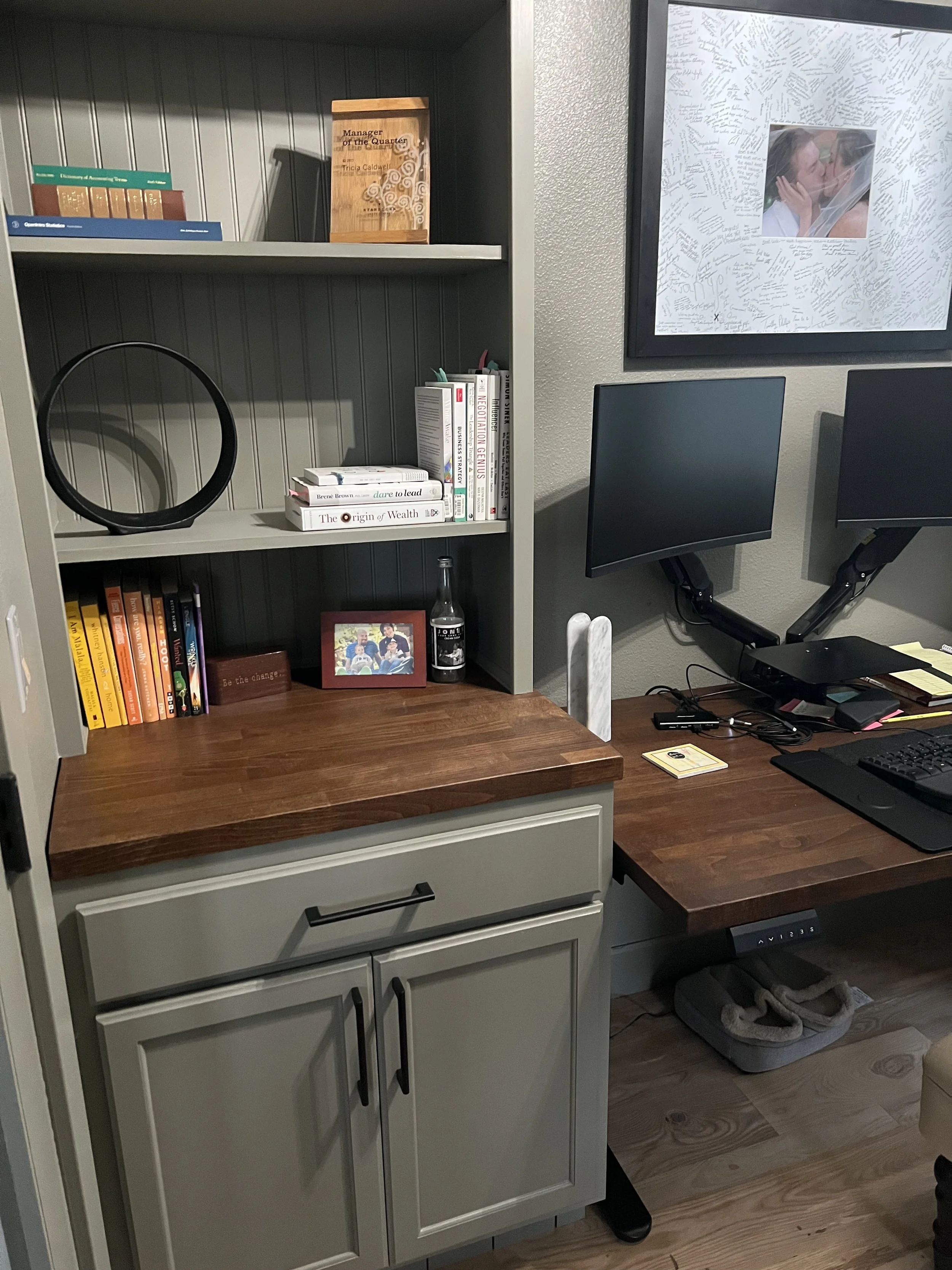 After renovation: A home office with built-in shelving above a wood counter and lower cabinets.