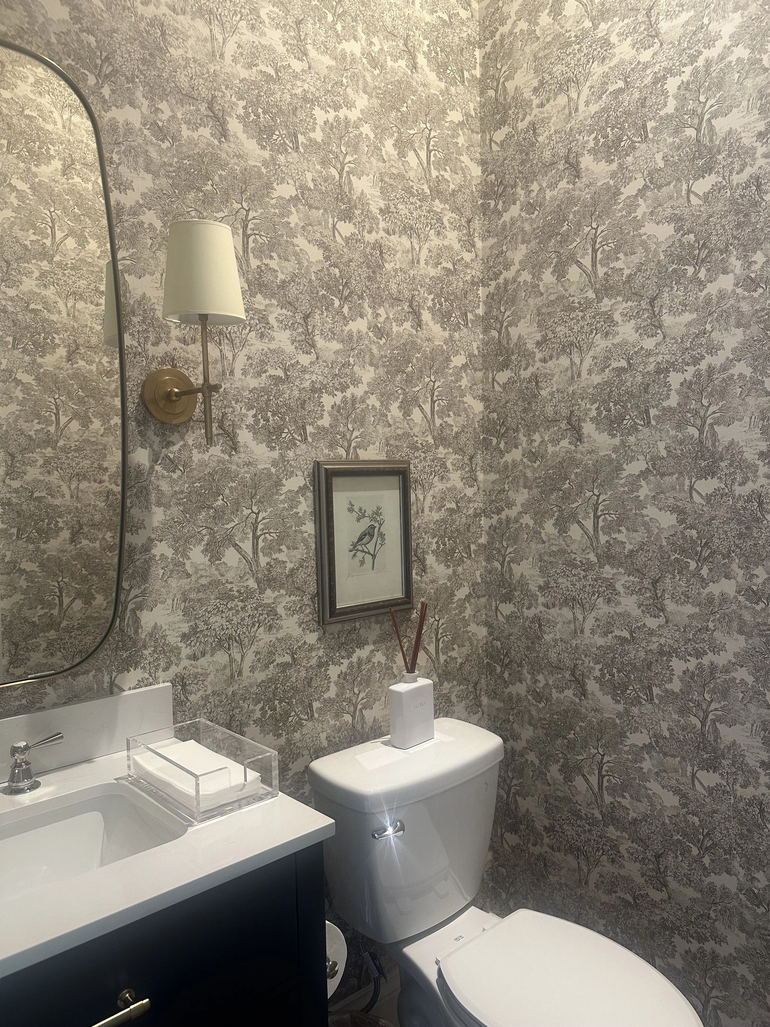 Powder room with botanical wallpaper and brass sconce, Portland, Oregon