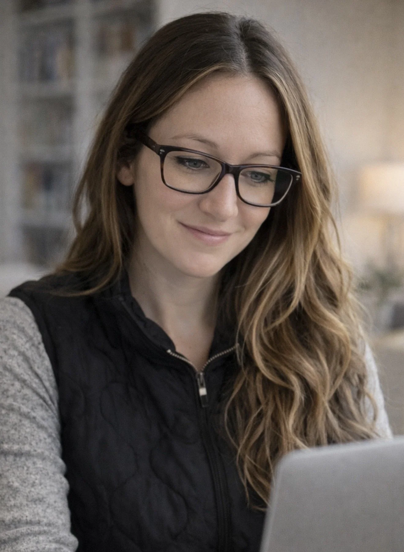 April Meehan, owner of Summit Elite Virtual Solutions, working on a laptop as part of her social media management and digital support business.