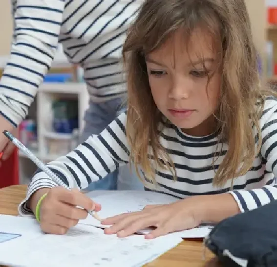 FASPS elementary student concentrating on a writing assignment