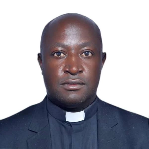 A portrait of a Black man dressed as a priest, wearing a black suit with a clerical collar, against a plain white background.