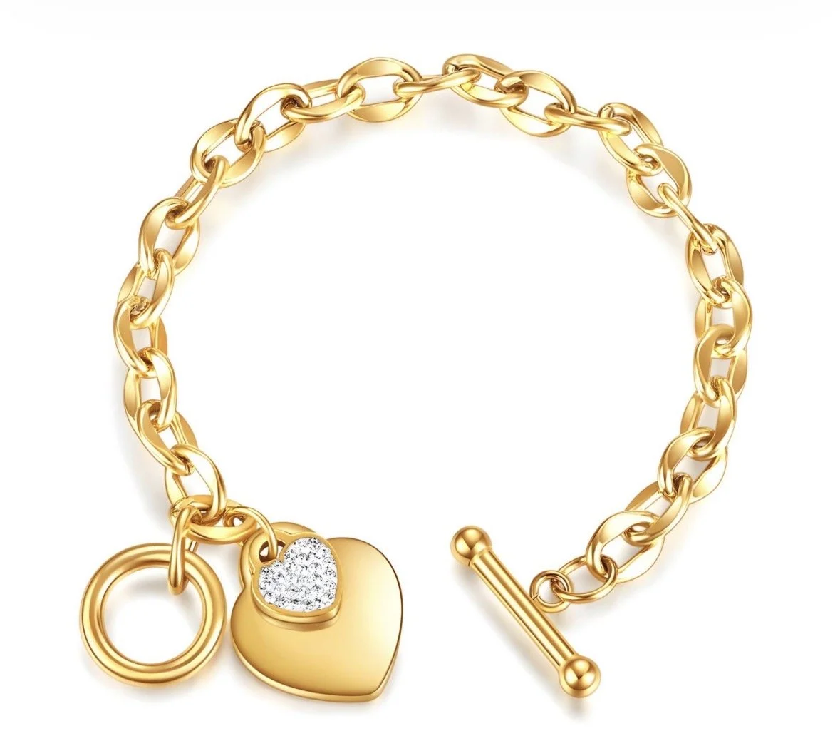 Gold chain bracelet with a heart-shaped charm and a toggle clasp.