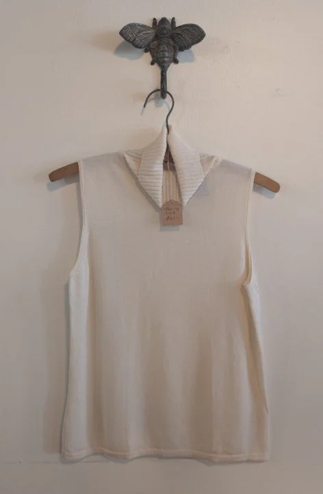 Cream sleveless turtleneck
