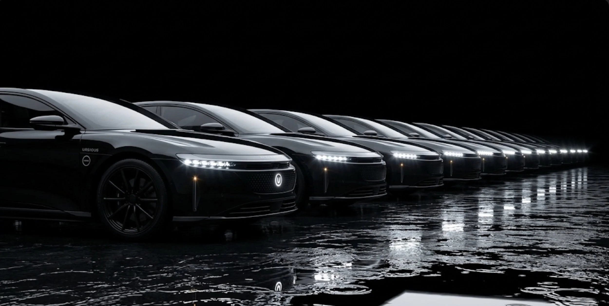 Multiple sleek, black electric cars lined up in a dark, reflective environment with illuminated front lights.