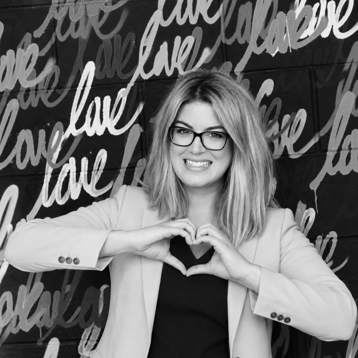 Allyssa DelPiano Strategic Marketing and Creative Design Auburn NY | Los Angeles  CA | Remote making a heart shape with her hands