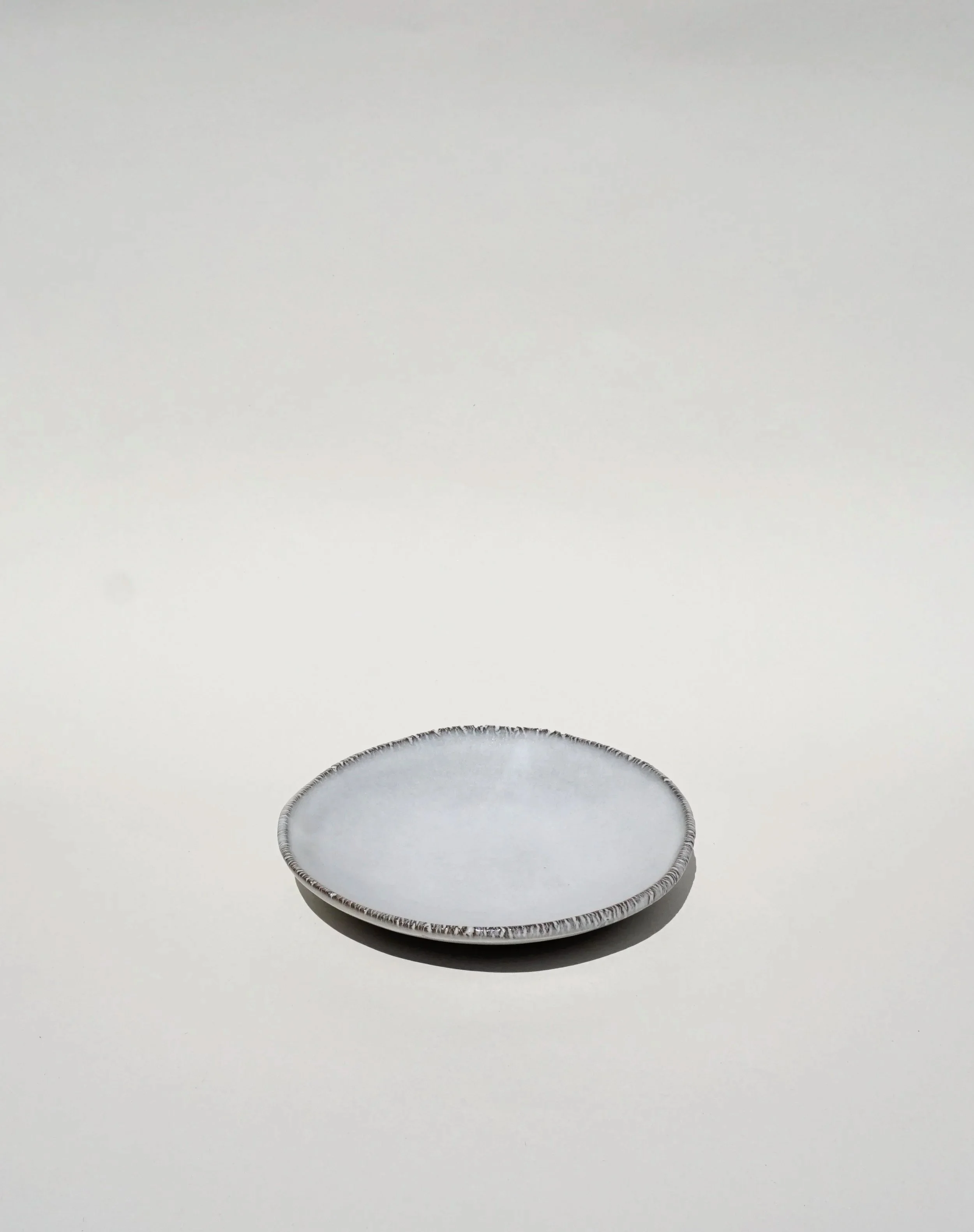 Black porcelain cake plate with a bright off white glaze
