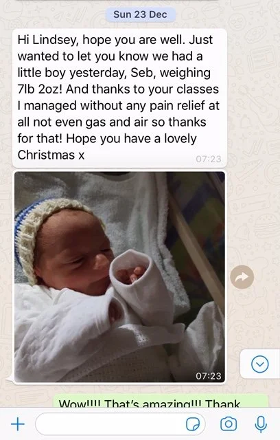 A screenshot of a WhatsApp conversation with a message and a photo of a newborn baby wrapped in a blanket, wearing a knit hat.