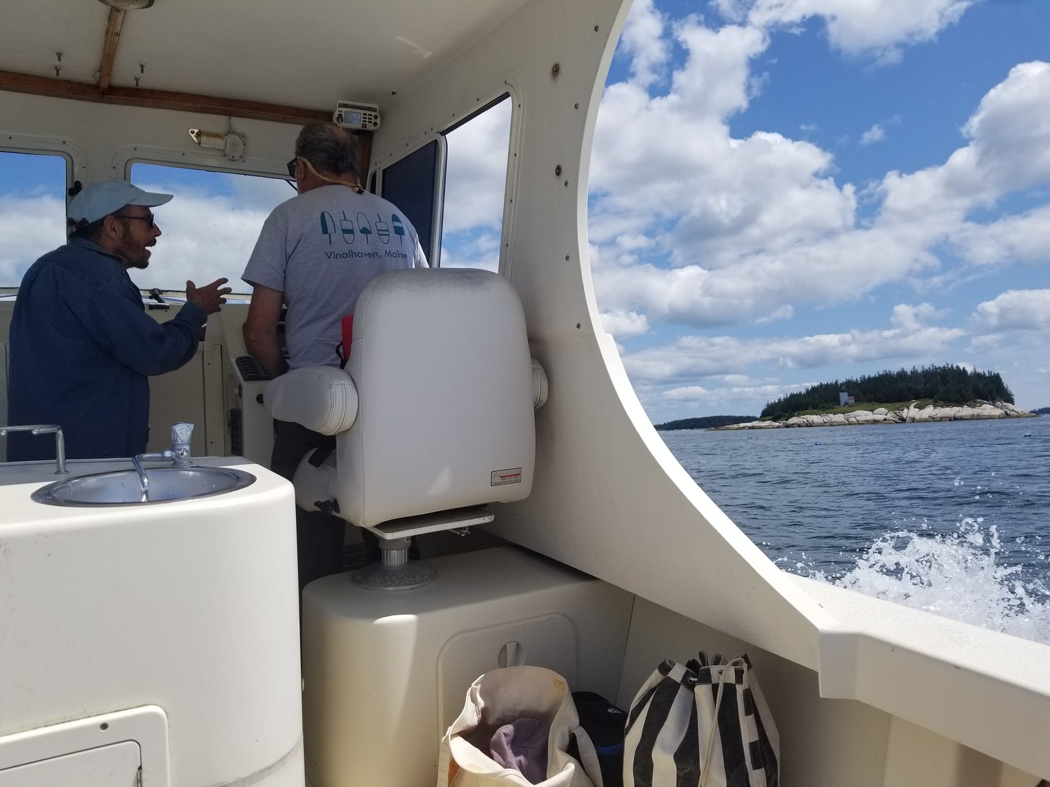 Joel and Avrum at helm with bags.jpg