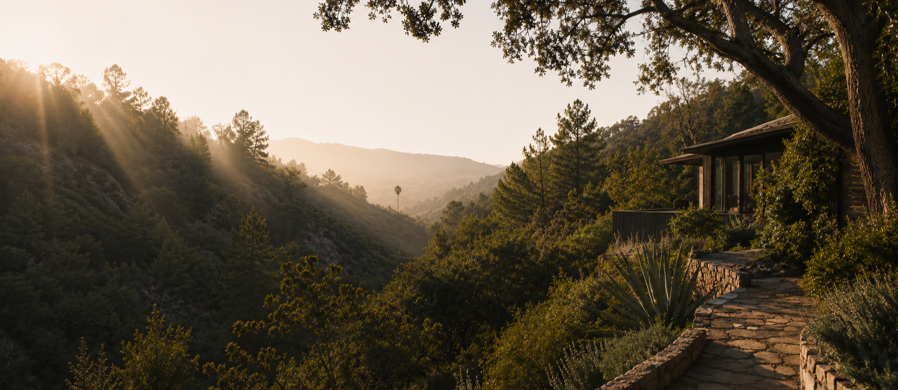 Stone pathway overlooking a wooded canyon property in Topanga at golden hour.