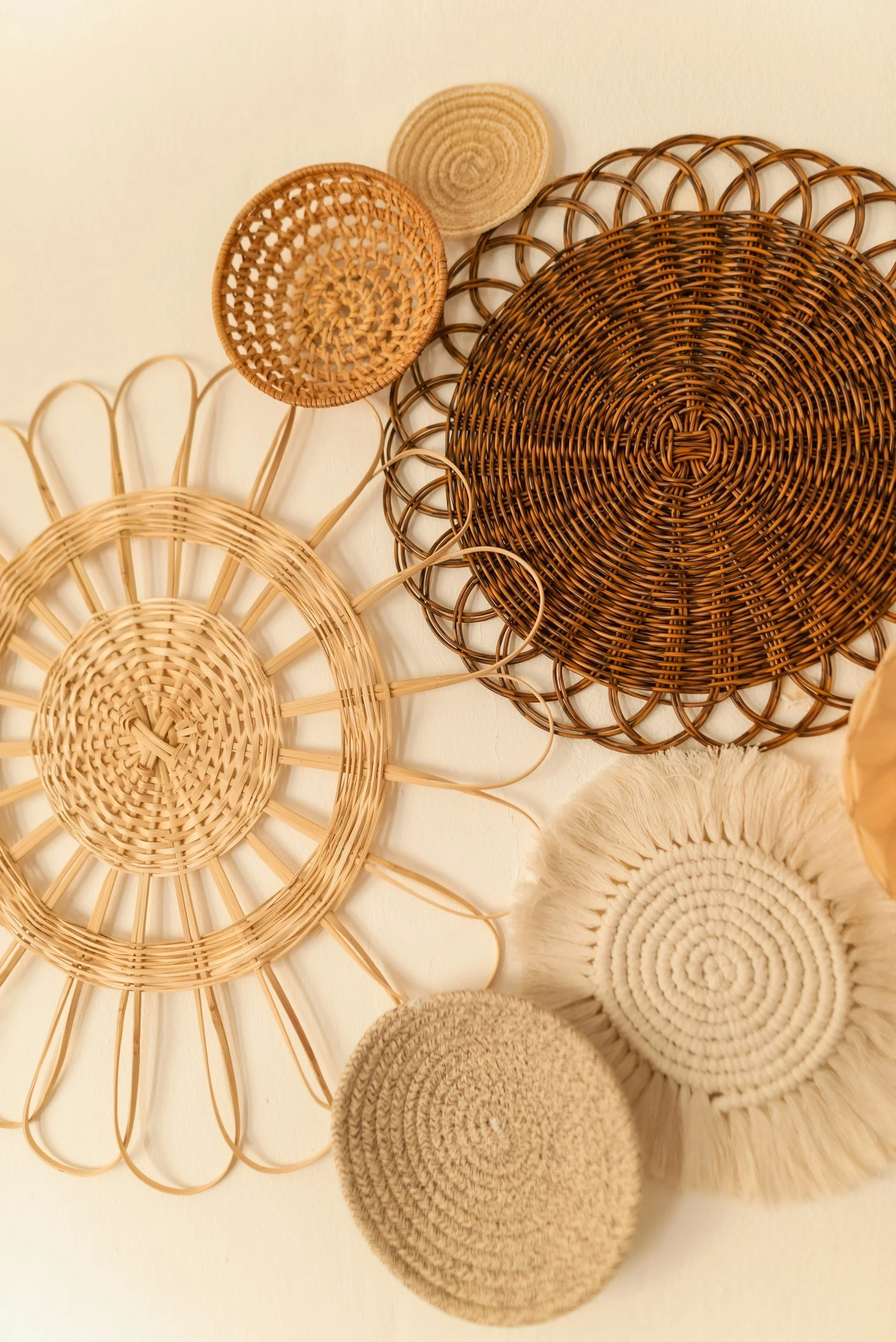 Wall decor made of woven rattan baskets arranged on a light-colored wall