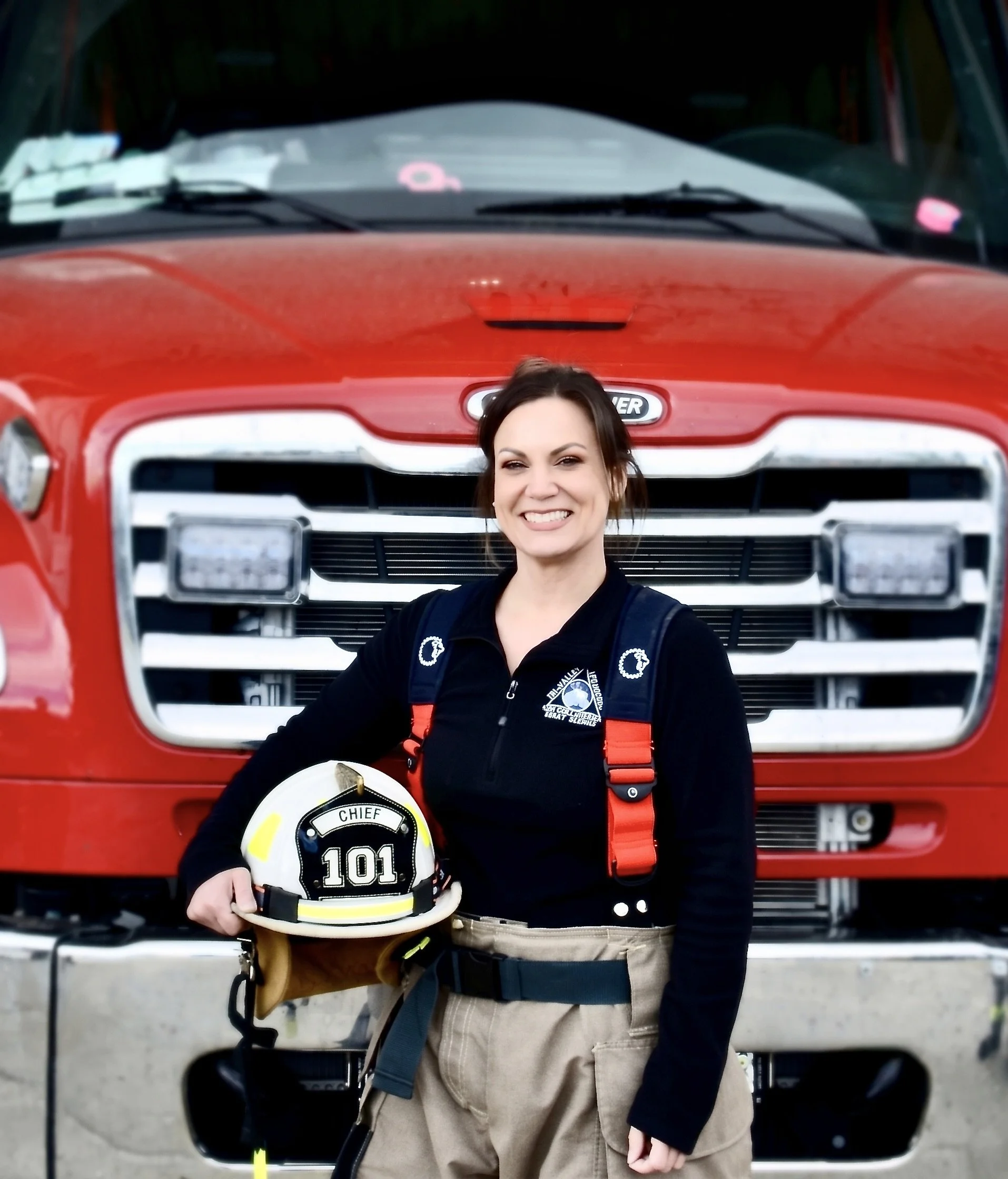 Cartoon boy dressed as a firefighter, wearing a red firefighter uniform with yellow stripes and a matching red firefighter helmet with yellow accents, standing confidently with a slight smile.