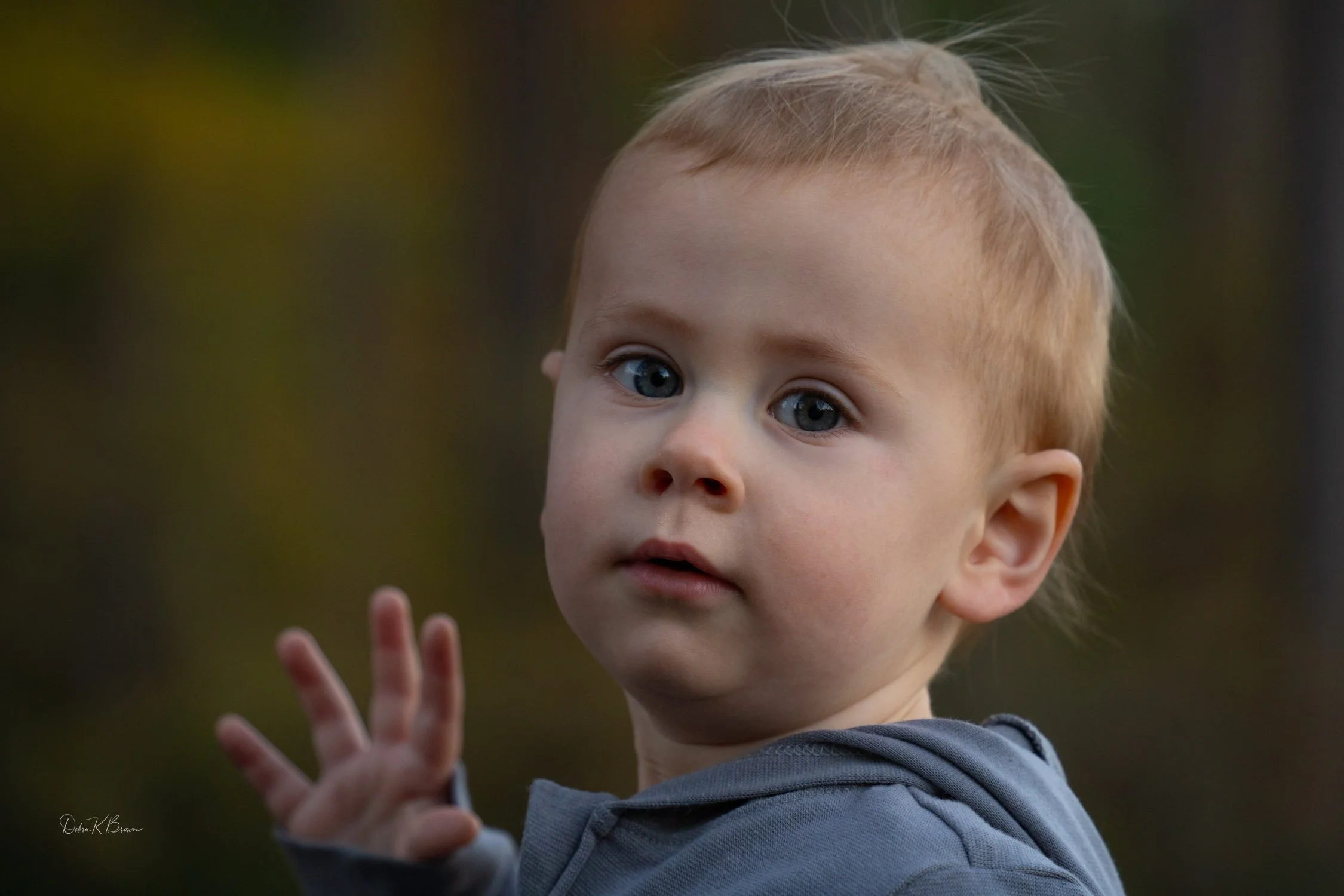Close-up of toddler outdoors with soft background