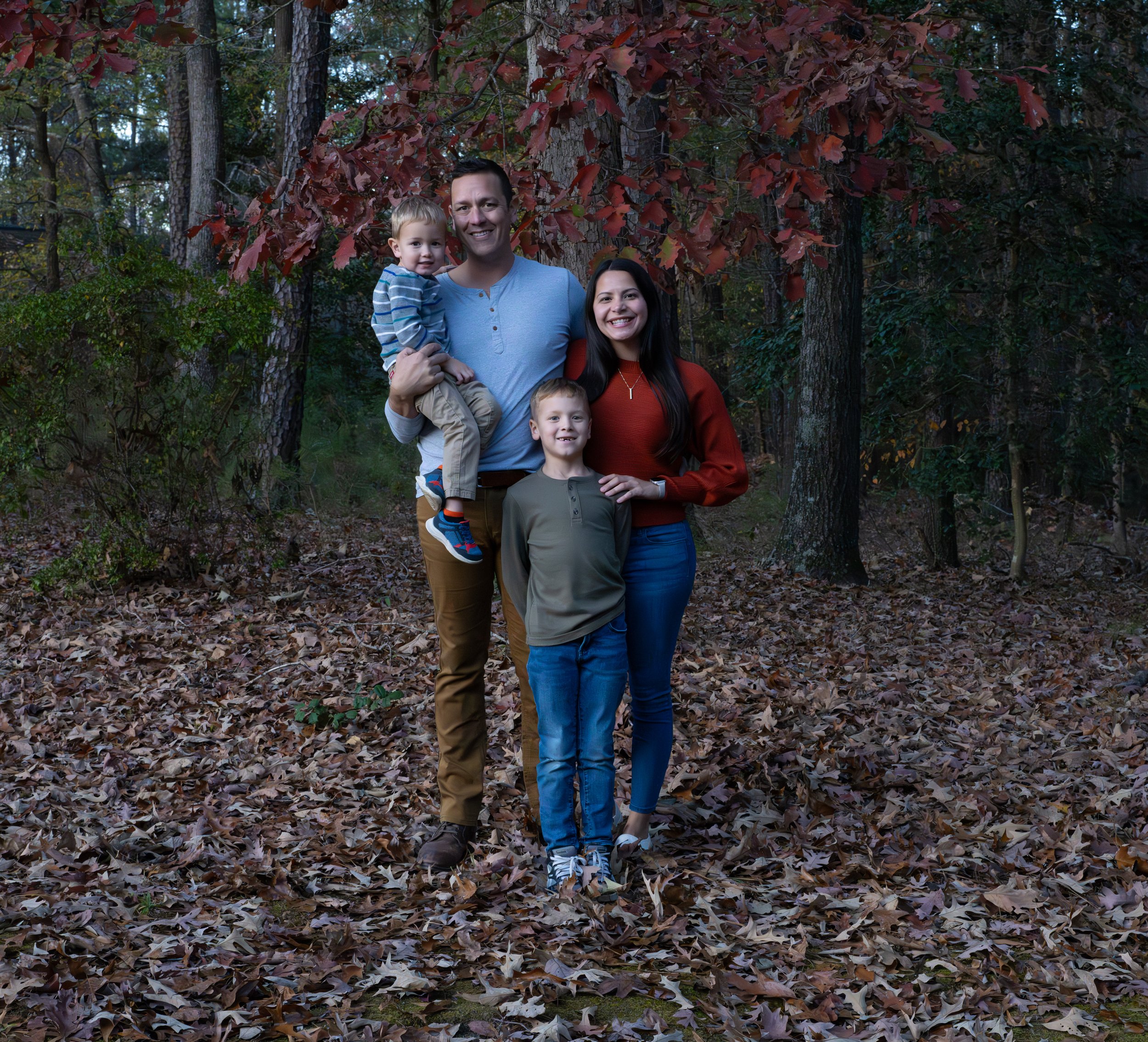 Family walking hand in hand on a forest path