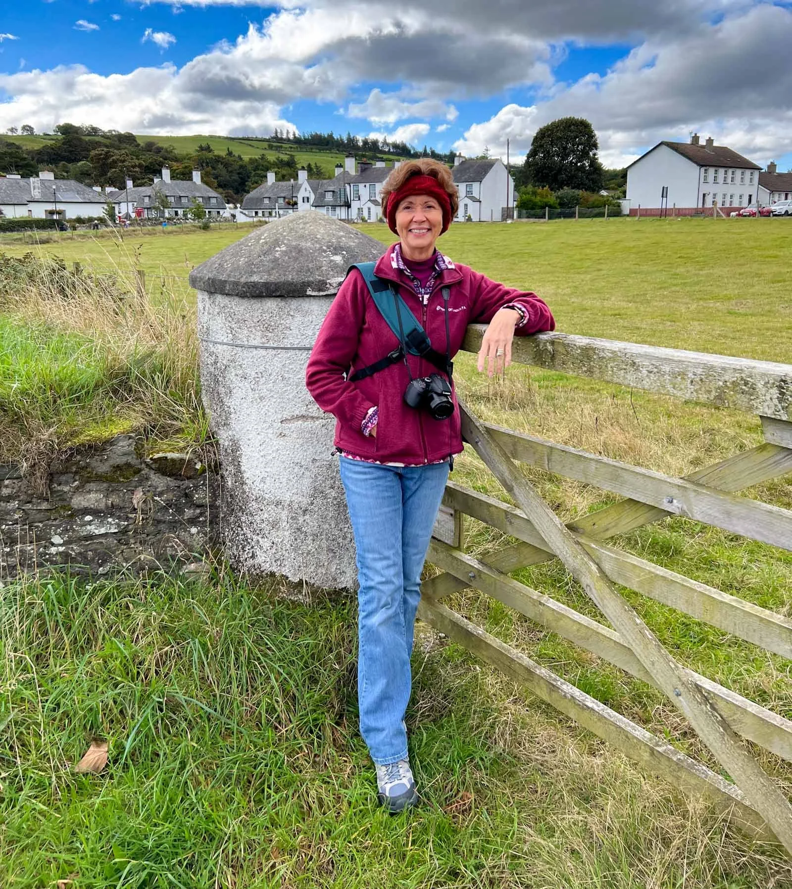 Debra K. Brown, photographer, smiling while holding camera during outdoor shoot
