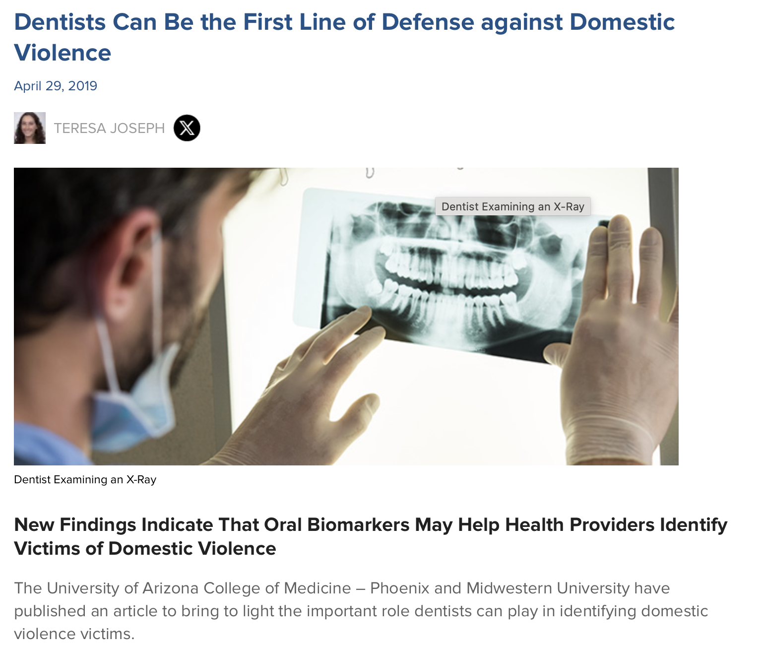 A dentist examining an X-ray of a person's teeth and jaw on a lightbox.