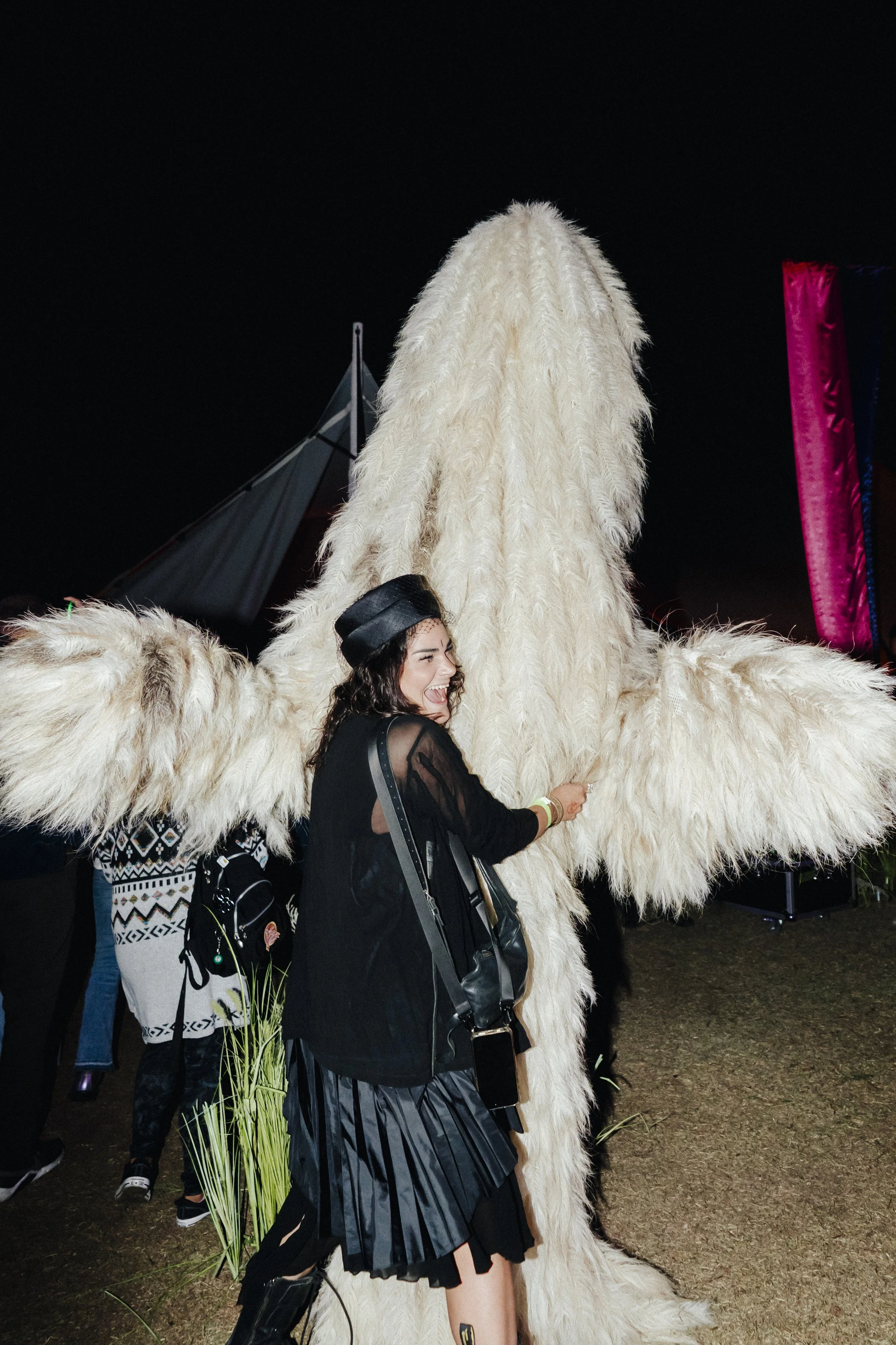 A woman hugs a large-scale archetypal leviathan figure at The Cortège.