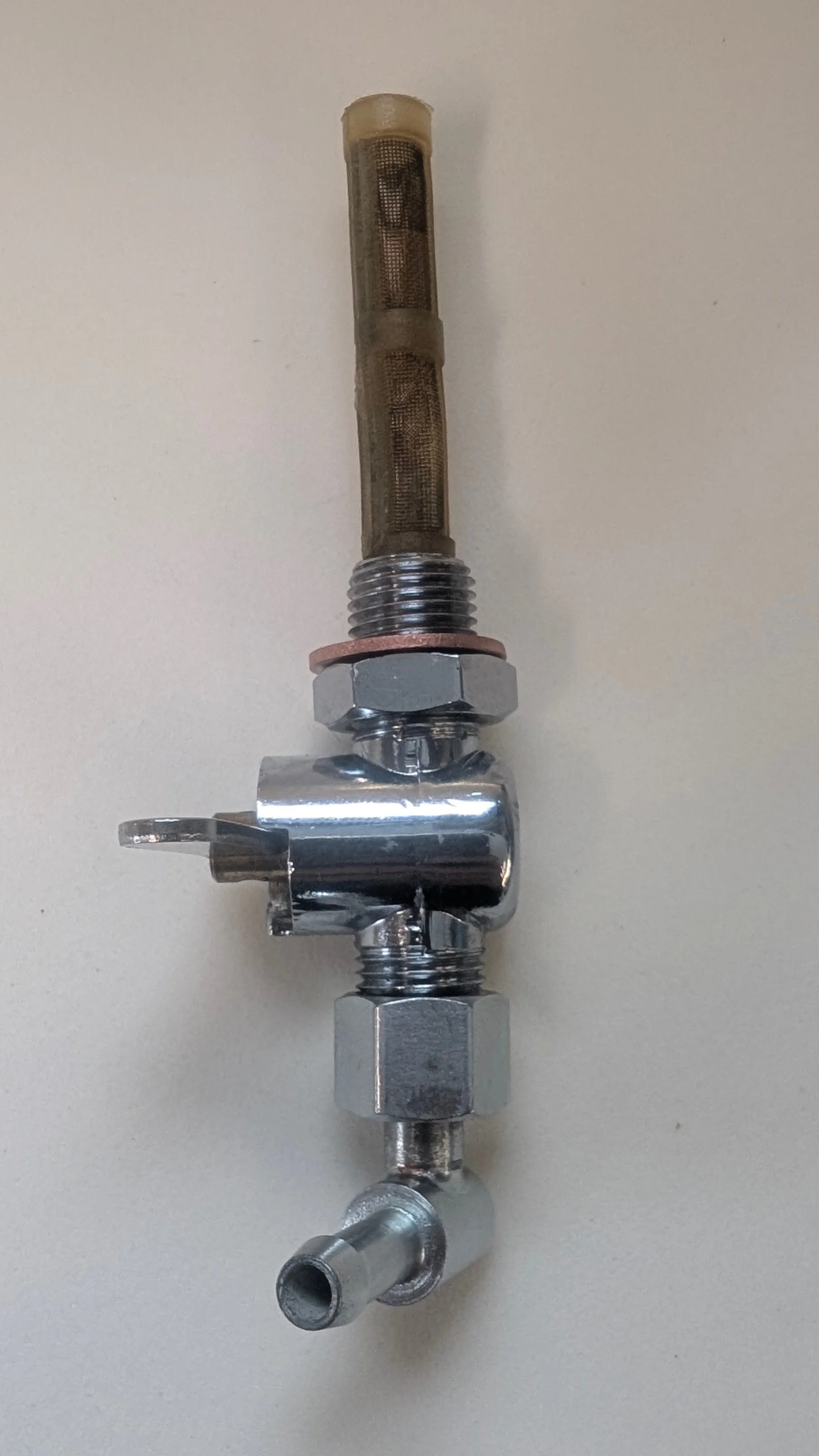 A metal spark plug with attached hose and fittings