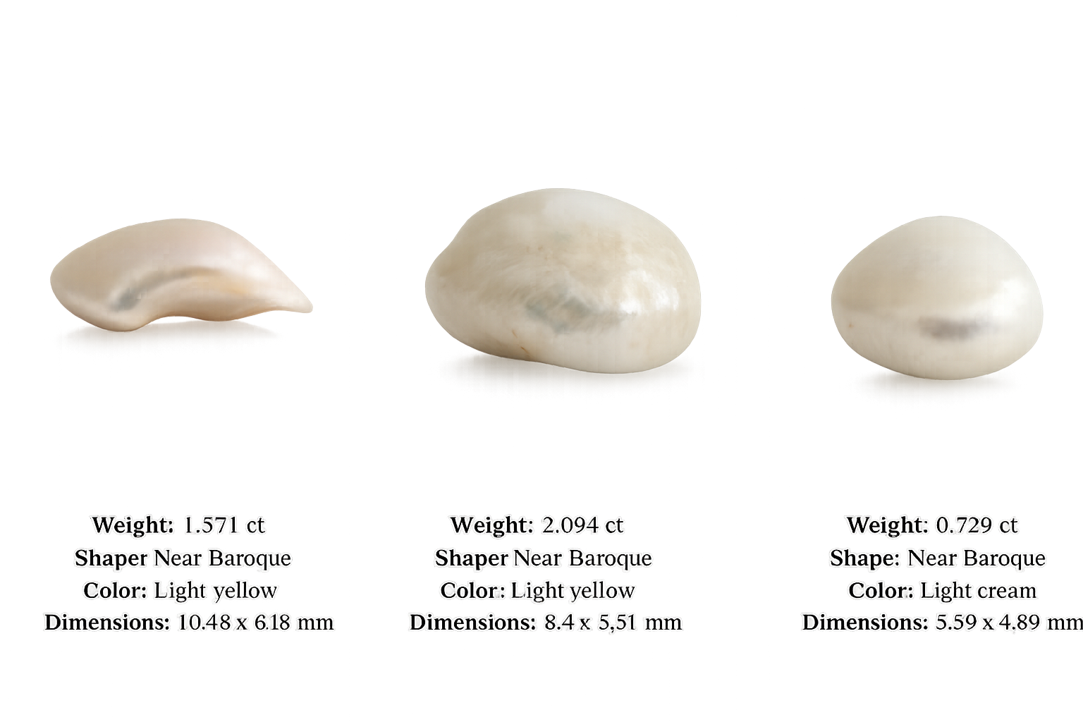 Three pearls of different shapes and sizes, each labeled with weight, shape, color, and dimensions. The first pearl is light yellow, shaped near Baroque, weighing 1.571 carats, with dimensions of 10.48 x 6.18 mm. The second pearl is also light yellow, shaped near Baroque, weighing 2.094 carats, with dimensions of 8.4 x 5.51 mm. The third pearl is light cream, shaped near Baroque, weighing 0.729 carats, with dimensions of 5.59 x 4.89 mm.