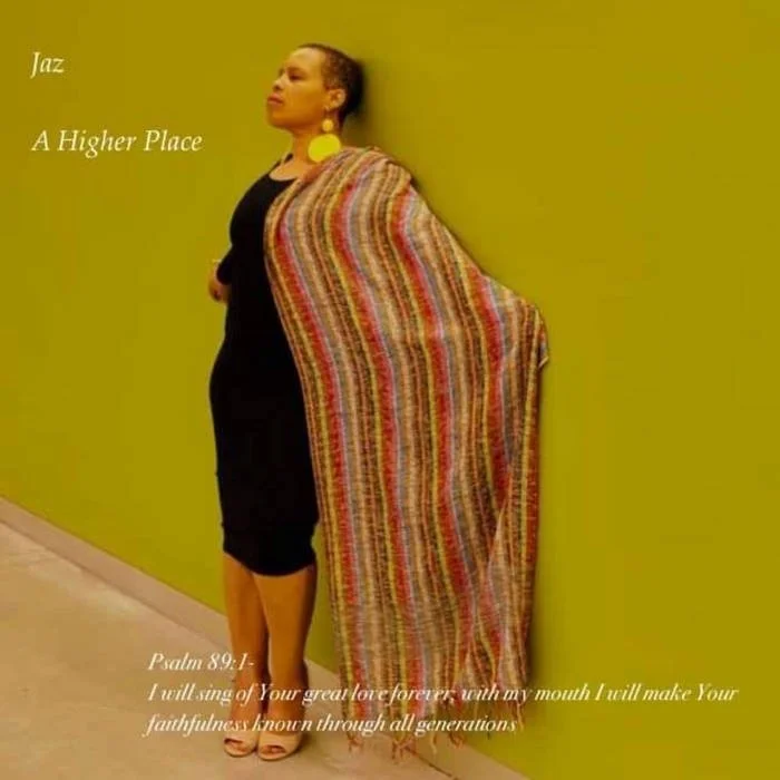 Jaz stands against a green wall, in a black dress, with yellow earrings, and a colorful shawl. It says: Jazz A Higher Place.
Psalm 89:1: I will sing of Your great love forever; with my mouth I will make Your faithfulness known through all generations