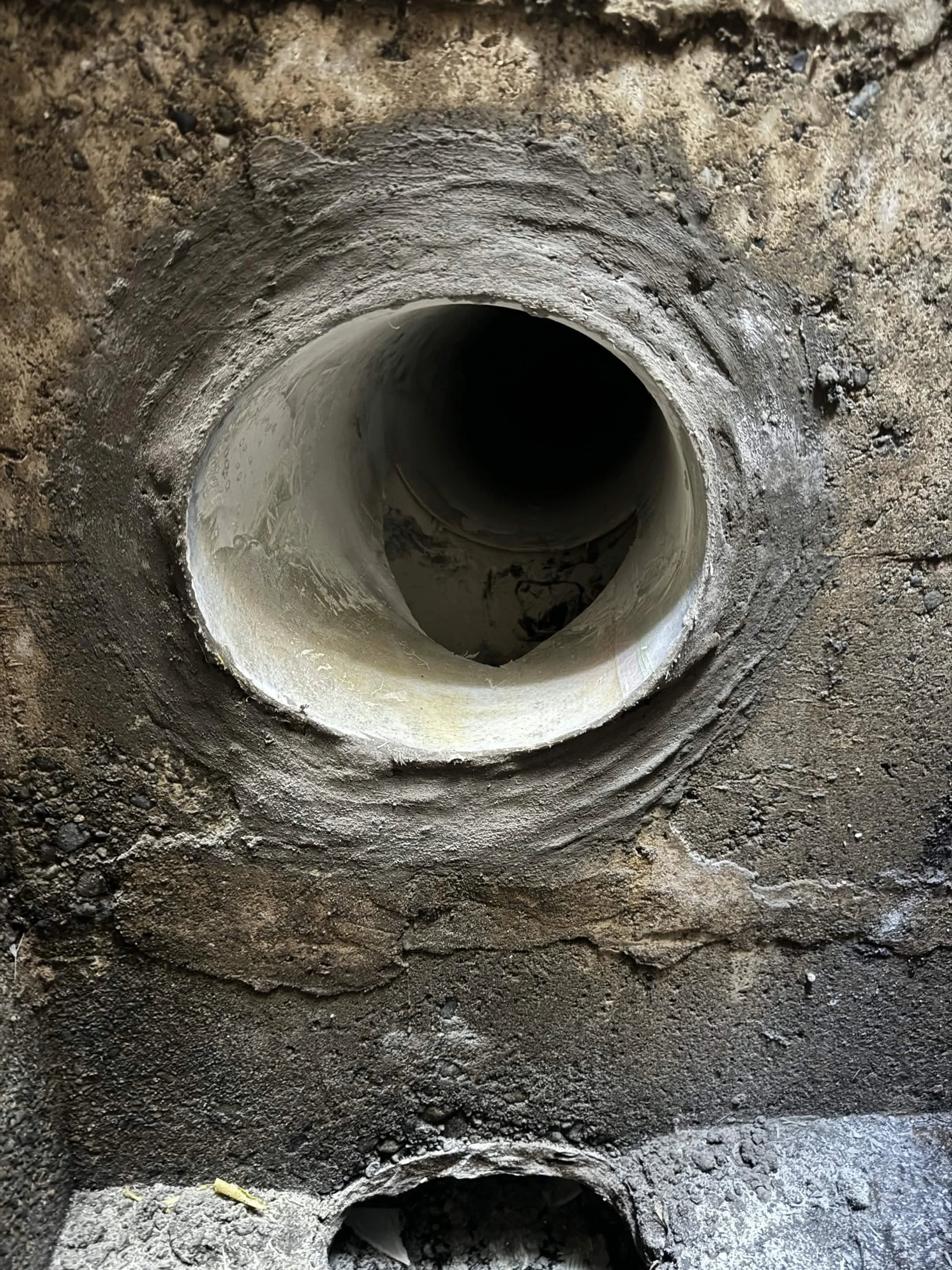 Parged connection in sewer manhole