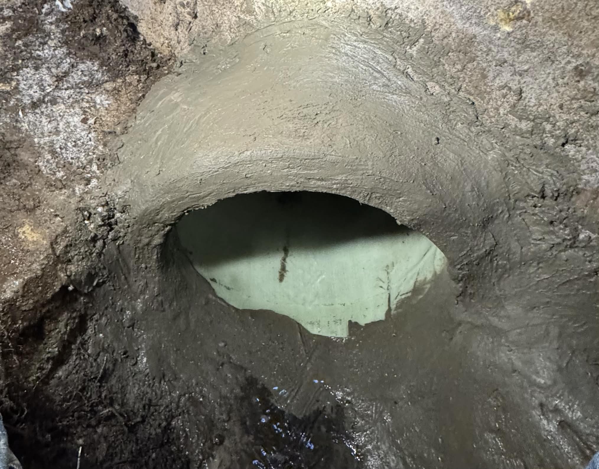 Parged connection in sewer manhole