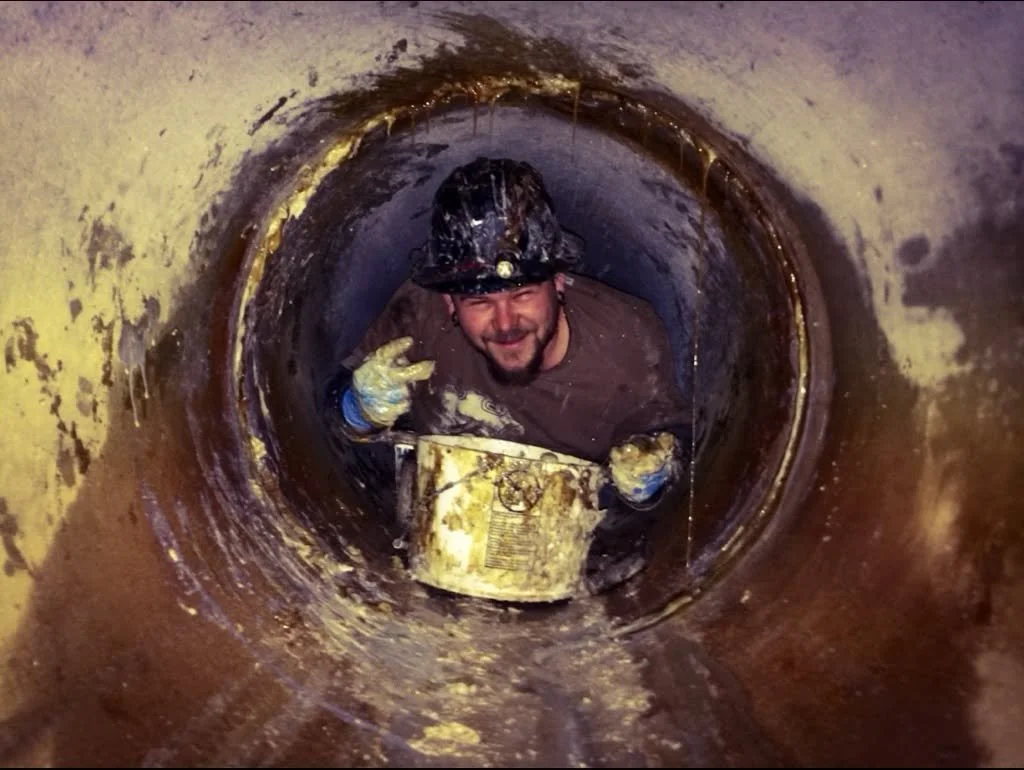Hand grouting leaking joint in storm pipe