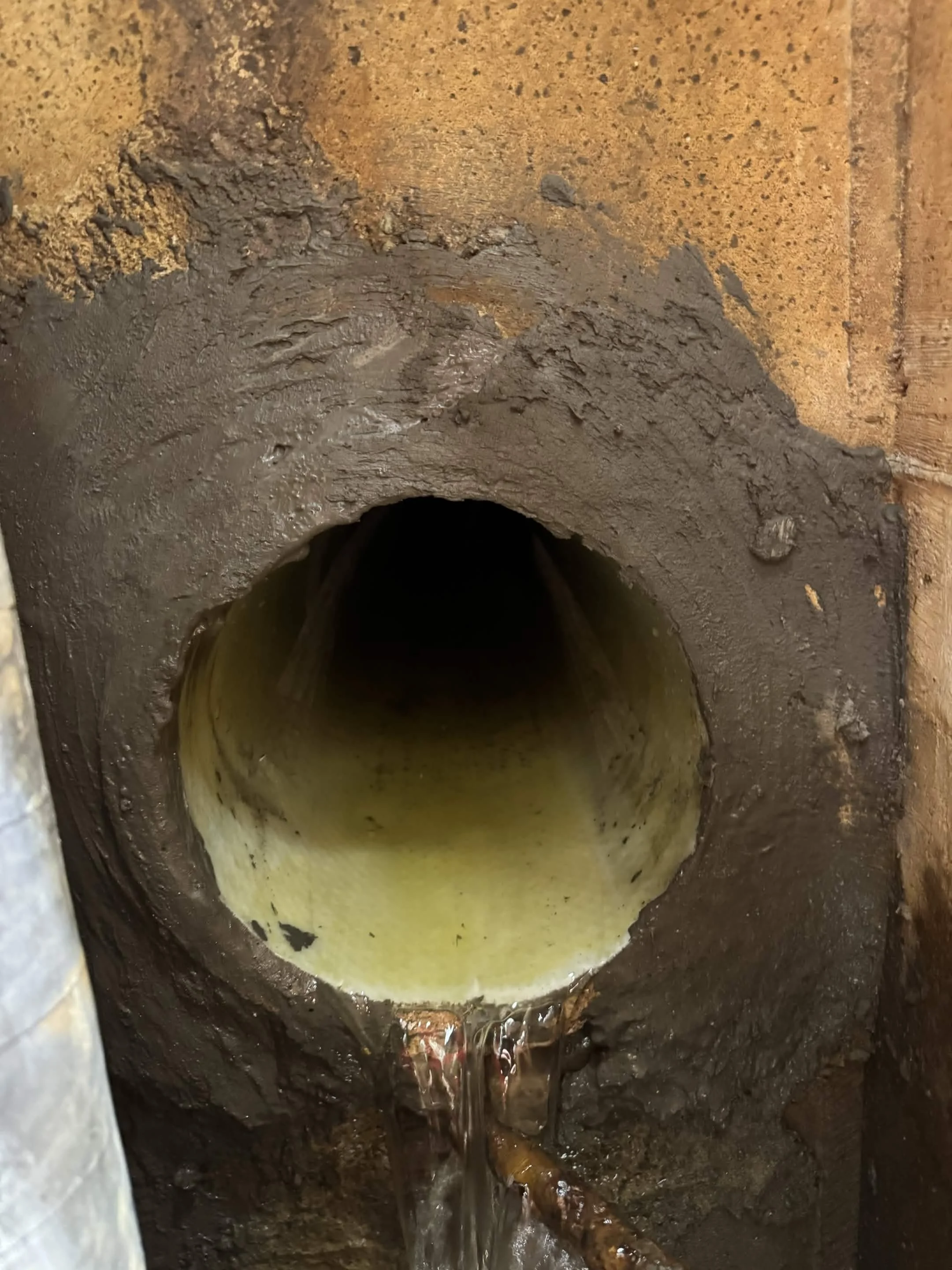 Parged connection in sewer manhole