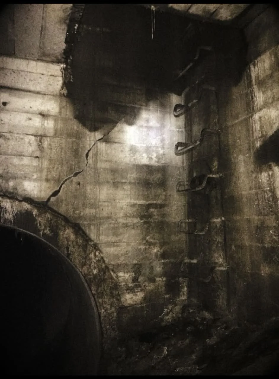 Sewer manhole access points with a large fracture.