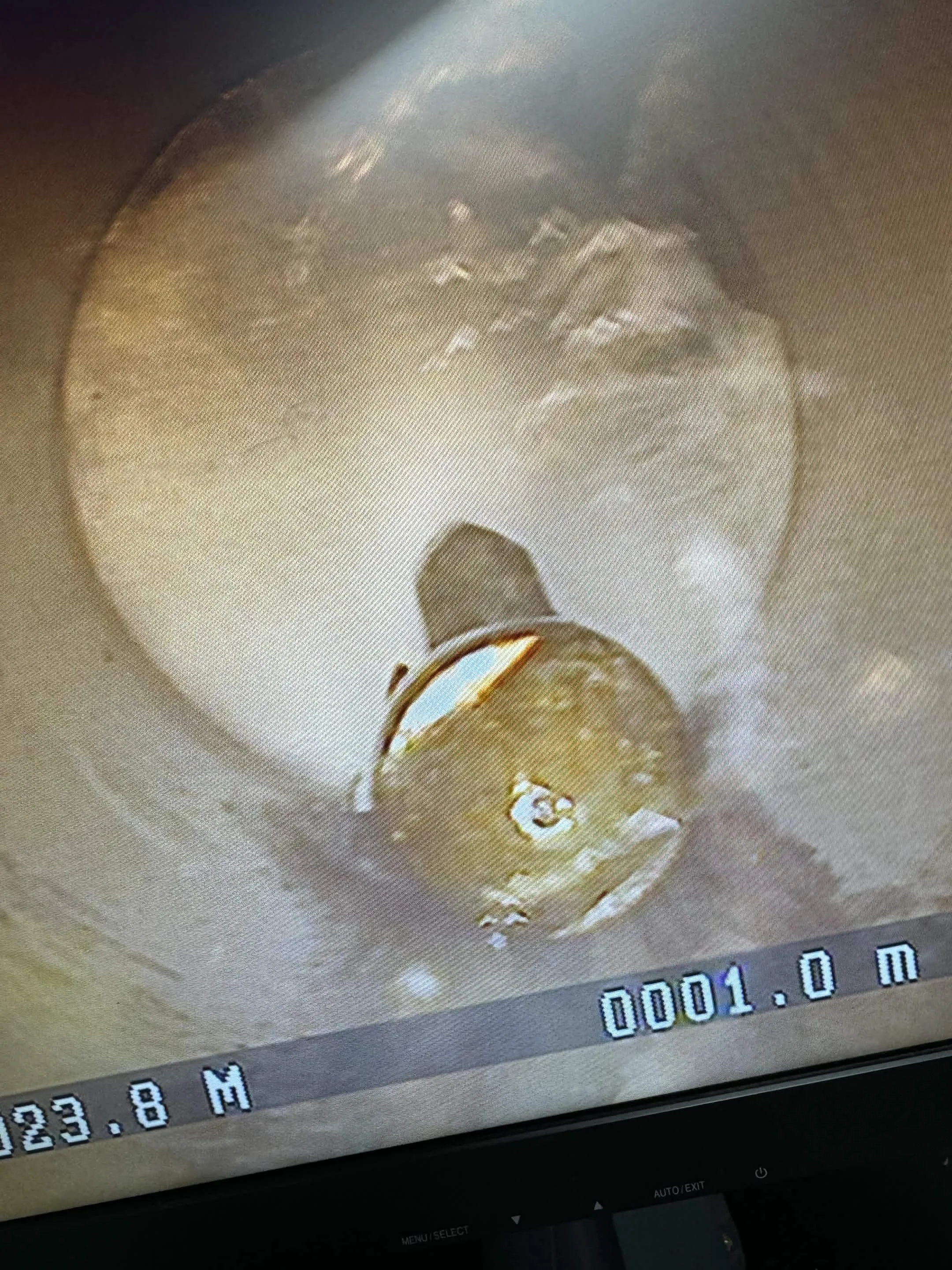 Jetter removing debris from sewer main