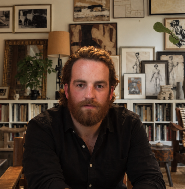Photo of author E L Klein sitting in office