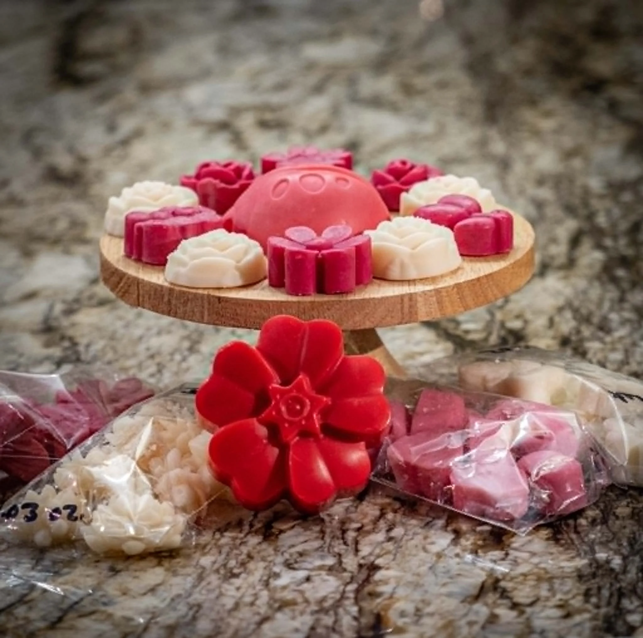 Colorful candies arranged on a wooden surface with a blurry background.