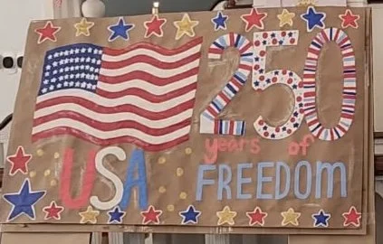 Decorative poster celebrating the 250th anniversary of the USA with an American flag, red, white, and blue colors, and the words '250 years of freedom'.