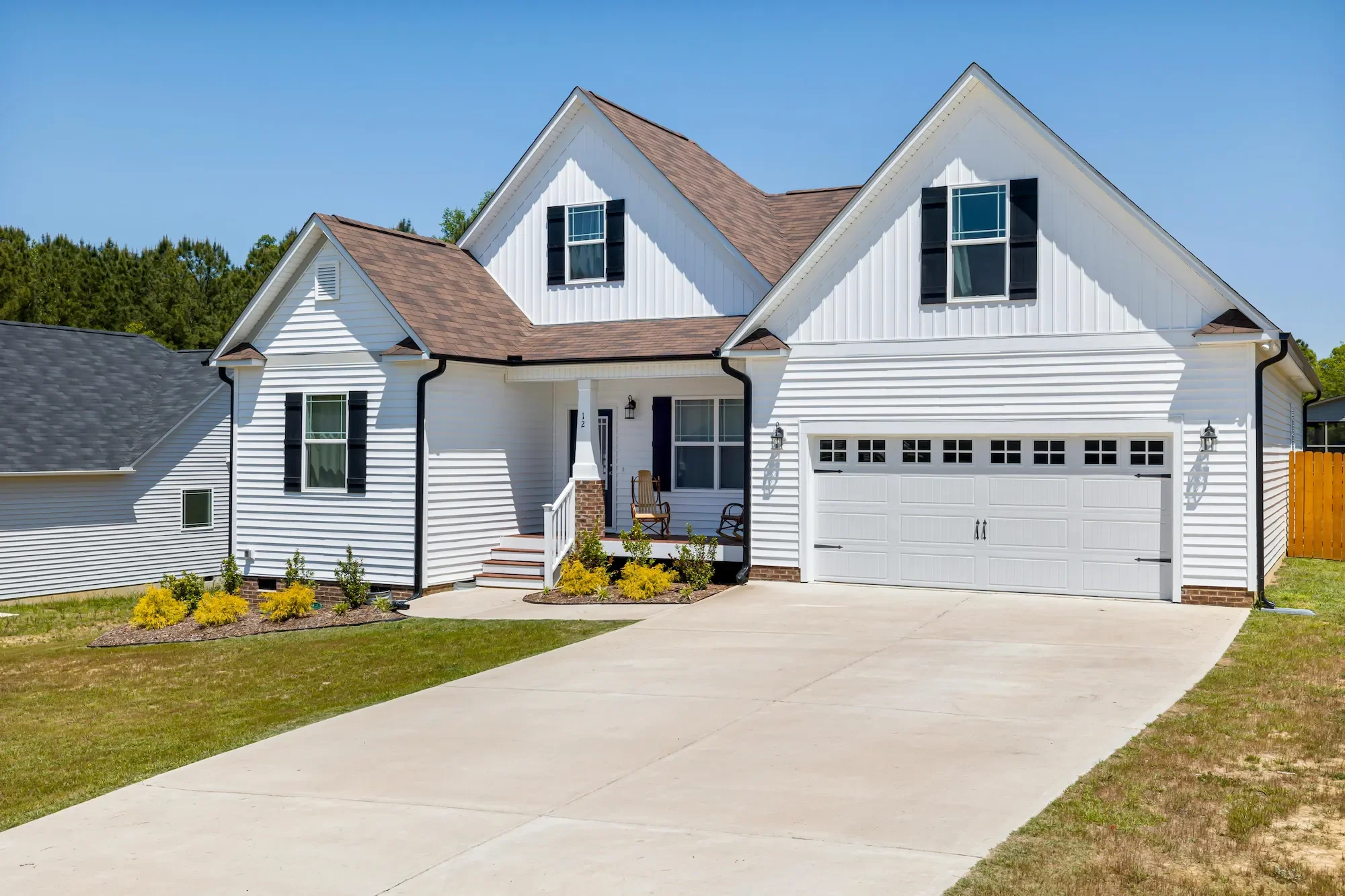 White home exterior with clean driveway — soft washing services for every surface in Johnson County KS
