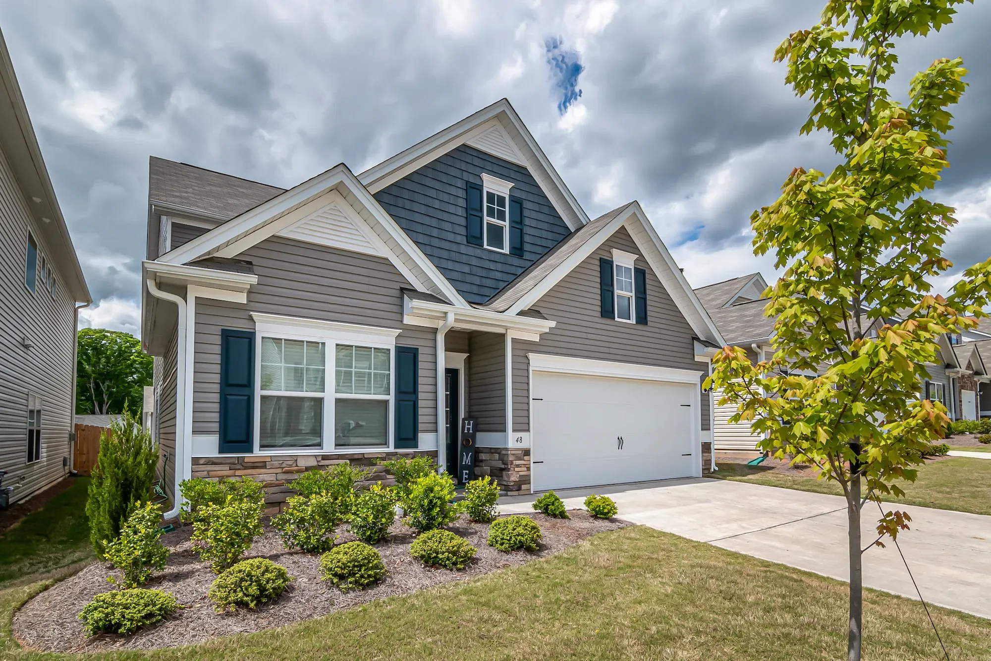 Johnson County home exterior before professional pressure washing service, front view from the street showing siding and landscaping