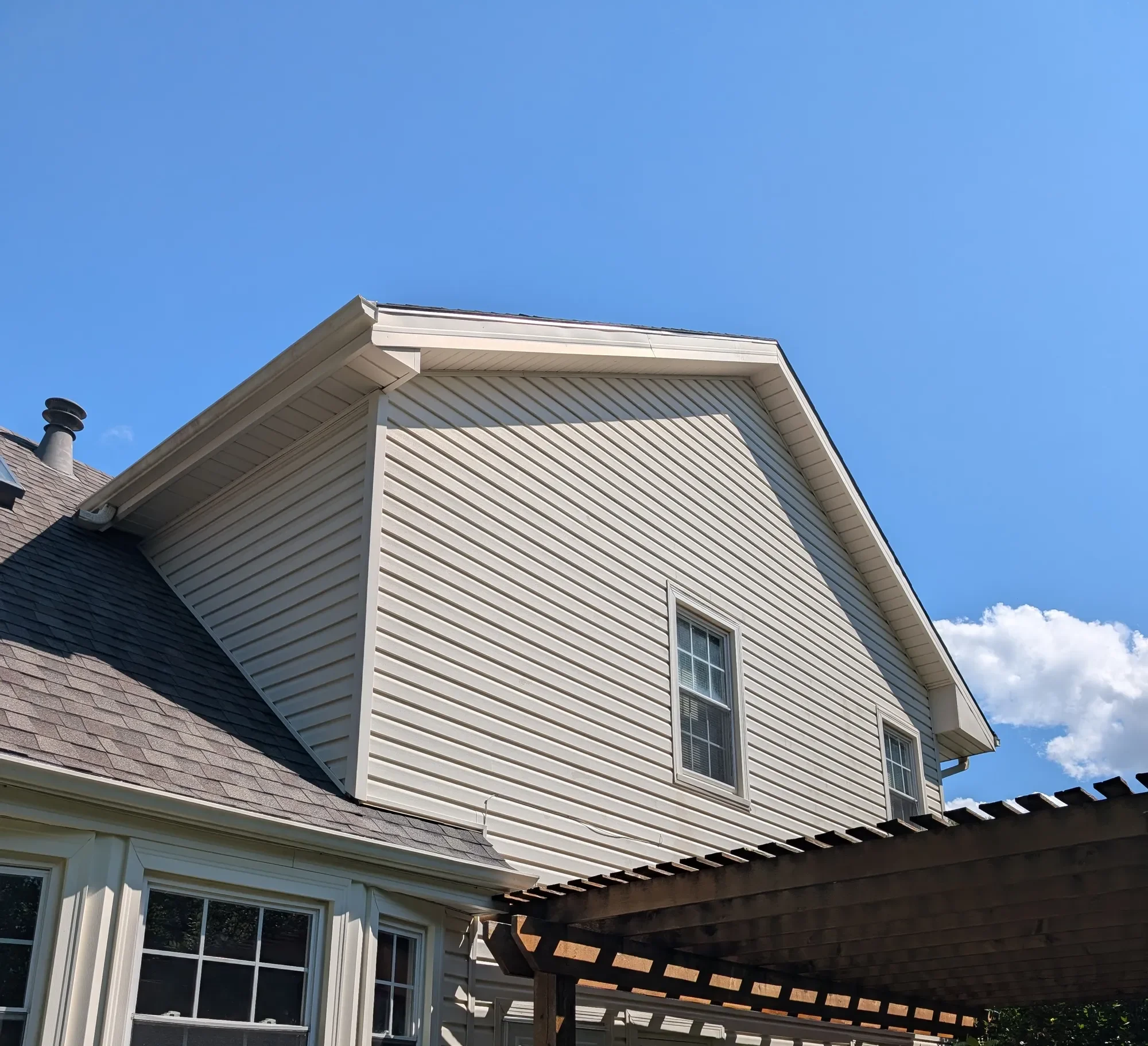 Clean rear house siding after soft washing by CurbSprout — Olathe, Johnson County KS