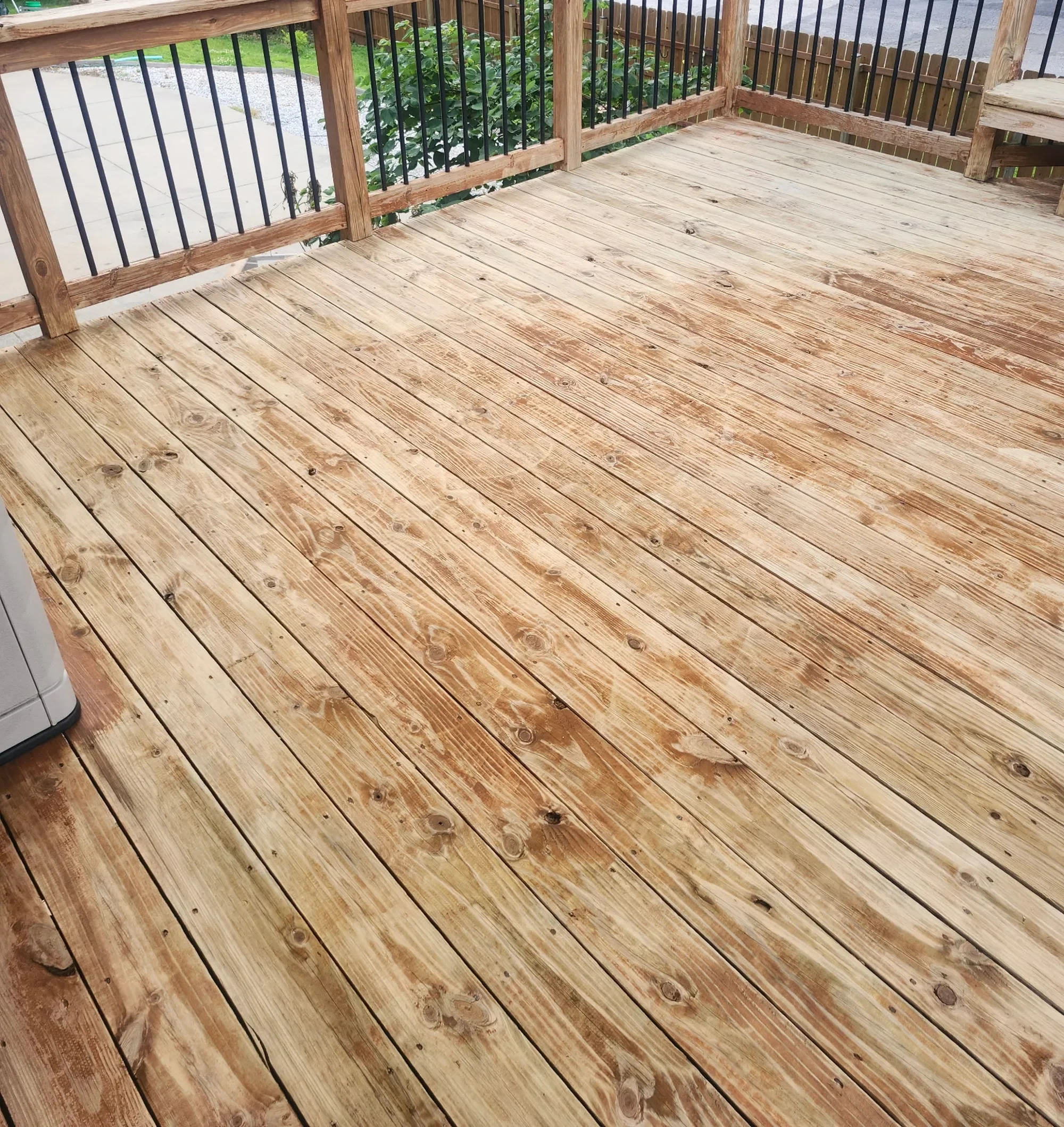 Wood deck after soft washing by CurbSprout — cleaned back to bare wood, Lenexa KS