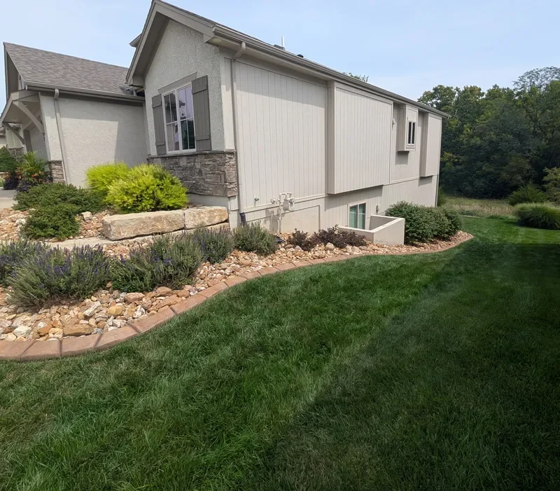 Home exterior showing stucco, Hardie board siding, and stone accents cleaned together in one soft washing visit.