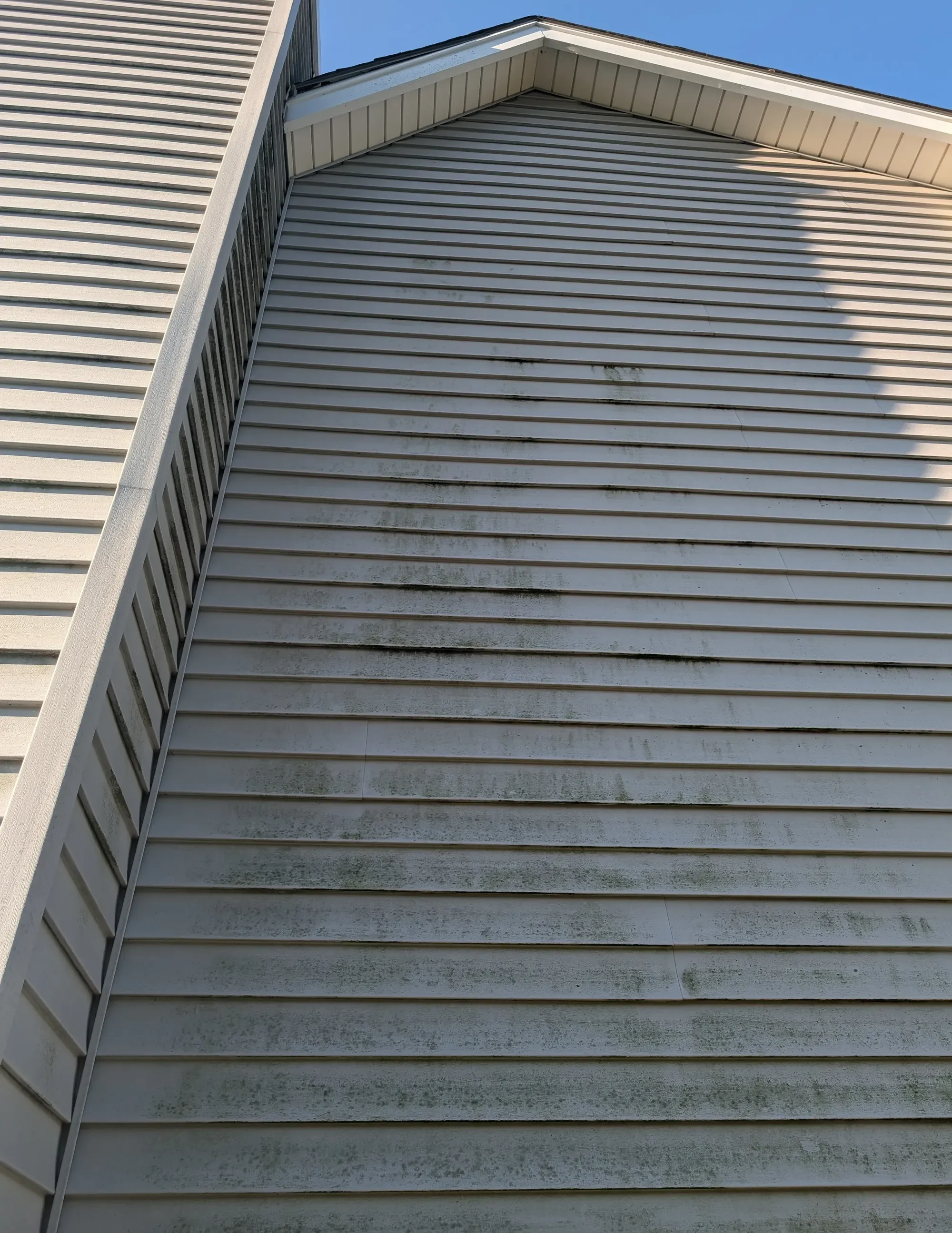 House gable with heavy algae banding before soft washing — Olathe KS