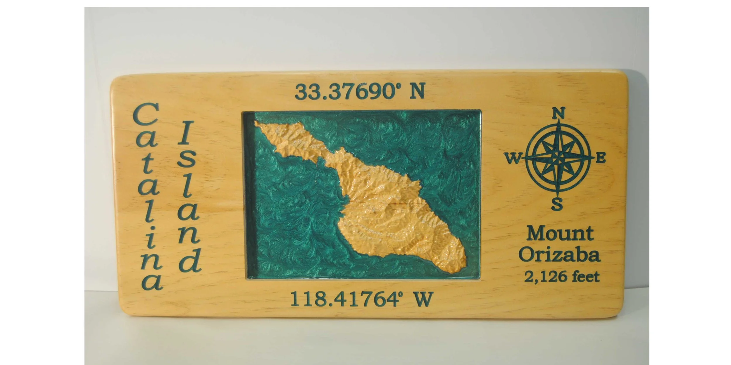 CNC 3D carved topographical map of Catalina Island with words and ocean filled with colored epoxy. 11 x 23 inches